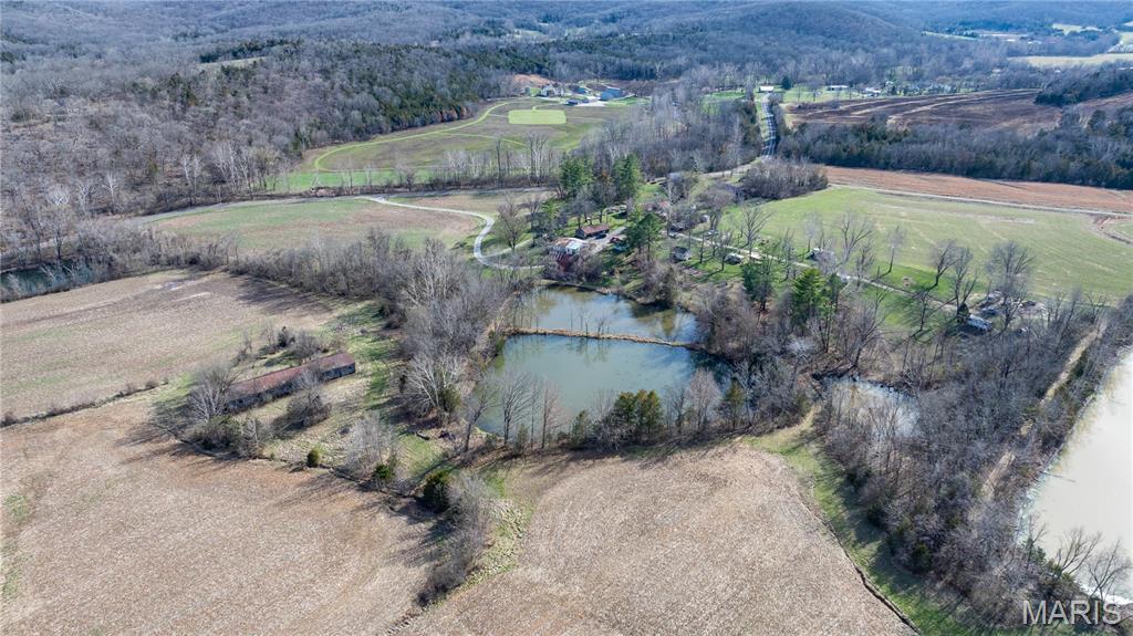 Discover an exceptional 140.54-acre recreational retreat in the heart of Missouri wine country near Augusta, Missouri. This remarkable property offers a rare blend of natural beauty, history, and outdoor adventure. With four fishing lakes, outdoor fire pits, abundant wildlife, and established areas for hunting, fishing, camping, and trail riding, it’s an ideal destination for outdoor enthusiasts or those seeking a peaceful private escape. Located one mile from Boone Valley Golf Club.

The property includes a 2-bedroom, 1-bath residence featuring a cozy wood-burning fireplace, along with a bath house,  and lean-to structures that provide ample space for equipment, storage, and gatherings. Two century-old log cabins add incredible historic charm and character, creating a setting that feels both timeless and unique.

Enjoy scenic picnic areas, wooded trails, and open land perfect for recreation, relaxation, or future development opportunities. Conveniently located in the renowned Augusta wine region, you’ll enjoy privacy while remaining close to local wineries, dining, and attractions. Whether you’re looking for a private recreational farm, hunting retreat, weekend escape, homesite overlooking wine country, or a unique investment opportunity, this extraordinary property offers endless possibilities.