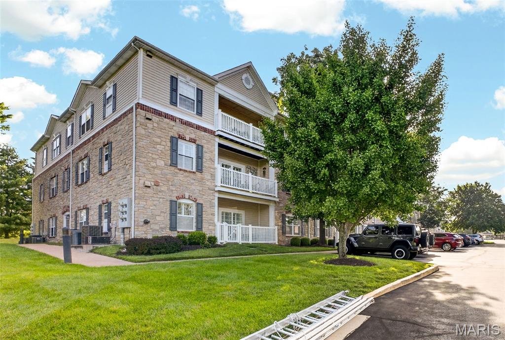 Welcome home to this beautifully maintained 2-bedroom, 2-bath end-unit condo in the desirable Monarch Trace community. Ideally located on the second floor (elevator available)  overlooking Central Park, this home offers peaceful views, abundant natural light, and a private setting that's hard to find. The open floor plan creates a bright, inviting space that's perfect for both everyday living and entertaining. Large windows frame beautiful park views, while the private covered balcony is the perfect place to enjoy your morning coffee or unwind at the end of the day.The kitchen is complete with upgraded cherry cabinetry, granite countertops, stainless steel appliances, a center island, and abundant counter space, making it ideal for both cooking and entertaining. It opens seamlessly to the dining and living areas, creating a warm and functional gathering space. The spacious primary suite features a walk-in closet and an updated bath with a custom shower. A generously sized second bedroom and full bath provide the ideal setup for guests, a home office, or both. As an end unit, you'll appreciate the additional windows, extra natural light, and added privacy.  The unit has one assigned covered parking space and elevator for easy access.  New HVAC,  new patio door to deck, toilets and vanities 2024. The location truly sets this home apart. Step outside to enjoy miles of walking and biking trails, with the Chesterfield Family Aquatic Center just a one-minute walk away and the new playground in Central Park only two minutes from your front door. You'll also be just a 5-10 minute walk from the exciting new Downtown Chesterfield development, featuring restaurants, shopping, entertainment, and community gathering spaces. Plus, you'll enjoy easy access to the Chesterfield Amphitheater, YMCA, Faust Park, Highway 40/64, and Highway 141, making it easy to enjoy everything Chesterfield has to offer. This is a wonderful opportunity to enjoy low-maintenance living in one of Chesterfield's most desirable communities with an unbeatable combination of location, convenience, and lifestyle.