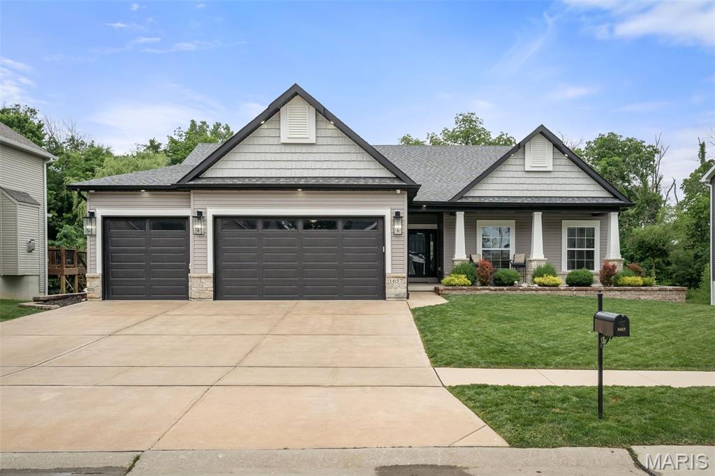 Welcome to 1657 Westlake CT, Pacific MO 63069, a turn-key single-family residence constructed in 2022. Located in the Villages of Westlake with private lake, pool, and cabana for neighborhood residents to enjoy. The heart of this home is an open-plan eat-in kitchen, seamlessly integrated with the living room. It features high ceilings, sleek stone counters, and a central island with a built-in farm sink, all complemented by high-end stainless-steel appliances and a premium range. The living room itself elevates the experience with its vaulted ceilings and centerpiece gas fireplace with custom mantle and stone hearth. Built in Bluetooth home stereo system features speakers in living room, garage, and front porch. The primary bedroom offers the convenience of an ensuite bathroom and walk-in closet providing a private retreat.   The second and third bedrooms feature walk in closets and share a full bath. The fourth bedroom comes complete with built in Murphy bed/armoires and office desk making great use of the space. Additional features enhance daily living, including a dedicated laundry room with built in cabinetry, custom hall trees, an attached, oversized, and insulated three-car garage, and permanent outdoor holiday lighting. Enjoy the outdoors on the inviting back patio or front porch, both perfect for evening gatherings! Schedule your private viewing today.