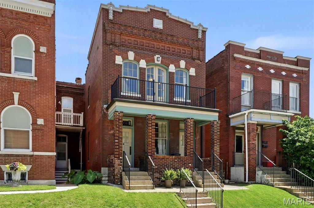 Welcome to Tower Grove East, one of our most beloved historic neighborhoods. This stunning 1908 brick home showcases the craftsmanship that defined St. Louis' architectural heritage, featuring eye-catching glazed brick, a stepped parapet and elegant Italianate limestone details.

Completely renovated in 2016, this former duplex is now a single-family home, with a custom floor plan designed for modern, multigenerational living. Warm pine floors on both levels create inviting spaces for everyday life and entertaining. At the heart of the home, the chef's kitchen is truly exceptional, featuring a large center island, breakfast bar and great pantry. Appliances include an induction cooktop and oven, built-in microwave, warming drawer - truly all of the things! The kitchen opens into a sought-after, main-level family room.  A bedroom and a full bath with walk-in shower round out the main level, perfect for when grandparents visit!

Upstairs, the expansive primary suite is a true retreat, complete with a coffee bar, sitting area and a dramatic wall of windows with access to the sweeping front balcony. The luxurious, light-filled primary bath features a custom-tiled wet room with soaking tub, and seamlessly connects to a professionally designed walk-in closet. There are two additional upstairs bedrooms, each with access to a back deck. One bedroom includes a Murphy bed, making it flexible space that works as a home office, workout room, or guest room. A generous hall bath, and a convenient second-floor laundry complete the upper level.

The outdoor spaces are equally appealing, with a welcoming covered front porch, expansive front balcony, and a spacious two-story rear deck. The back decks overlook a park-like neighborhood orchard that is permanently protected as green space! With the orchard as a backdrop, you're free to enjoy the low maintenance, fenced backyard, with parking pad and a paver patio!

Located just off Arsenal, the home offers quick access to Downtown and major highways, and also boasts one the city's highest walkability scores. Stroll to Tower Grove Park, Jay International Food Co., neighborhood cafés, and the acclaimed restaurants of South Grand. Showings begin July 9th —don't miss this extraordinary opportunity to own one of Tower Grove East's most distinctive homes.