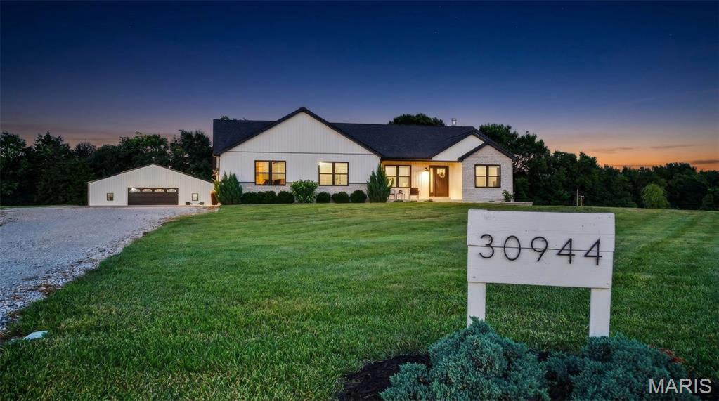 Welcome home to this beautifully designed 4-bedroom, 3-bath ranch situated on 3 scenic acres just 10 minutes from the charming town of Warrenton. Offering thoughtfully designed living space with high-end finishes and the space to enjoy the lifestyle you’ve always imagined.
The inviting open floor plan centers around a spacious family room with a cozy wood-burning fireplace, flowing seamlessly into the kitchen where you’ll find a large island, quartz countertops, custom cabinetry, a coffee bar and walk-in pantry perfect for entertaining and everyday living. The private primary suite features a walk-in closet and gorgeous ensuite bathroom. Main floor laundry and two secondary bedrooms complete the main floor. 
The finished lower level is an entertainer’s dream, complete with a custom wet bar with wine fridge and striking quartz countertops overlooking a spacious family room highlighted by a trendy electric fireplace. The lower level also offers a playroom/flex space , full bath, and fourth bedroom with an egress window while still  having ample storage space. Next, Step outside and embrace the lifestyle you’ve been dreaming of. Grow your own vegetables in the fenced raised-bed garden, collect fresh eggs from your own chicken coop, or simply relax and enjoy the peaceful setting from the expansive concrete patio overlooking your acreage.
Need room for your hobbies and toys?  Check out The incredible 40’ x 48’ pole barn complete with concrete floors, a wood-burning stove and electric. Whether you own classic cars, ATVs, UTVs, boats, campers, tractors, woodworking equipment, or simply need exceptional storage, this versatile space is ready for all your hobbies and adventures. This exceptional property delivers the best of country living without sacrificing modern style or convenience. Showings start 7/16!