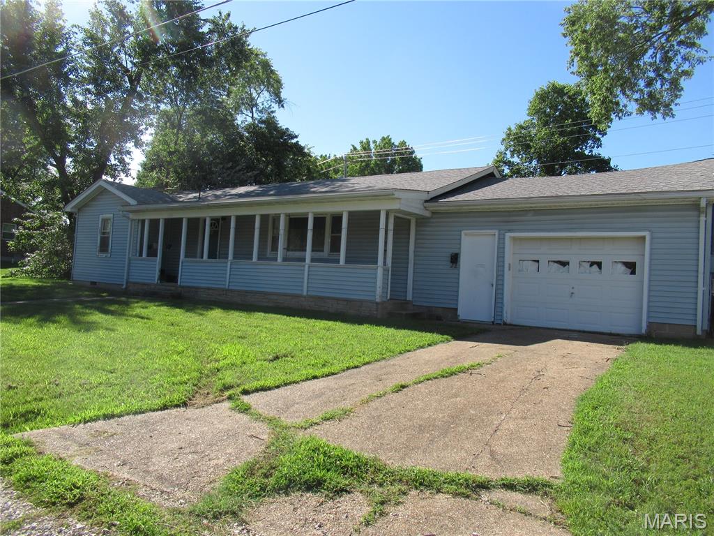 H2256  GREAT SOLID HOME WITH LARGE TREE-SHADED LOT!  Come remodel it and give it your personal touches. Sellers are selling "As Is". Three bedrooms, large living room and eat-in kitchen. Kitchen has an electric range with vent hood, refrigerator, 2 lazy susan cabinets and an eating bar. There is room for a large kitchen table. Hardwood floors in bedrooms and living room. Gas water heater and gas furnace. Oversized single car garage with washer/dryer that stays. Furniture in home will stay. Storage shed behind home for your yard storage items. 5x30 Covered front porch. This is priced right so you can make the necessary updates and repairs.