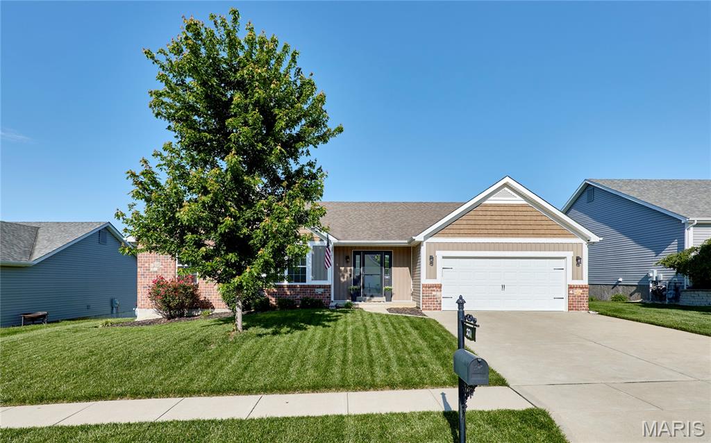 Discover this stunning 3-bedroom, 3-bath ranch, offering over 3,000 sq. ft. of meticulously maintained living space that perfectly blends modern style with everyday comfort. The open-concept floor plan is anchored by a spacious Great Room featuring soaring vaulted ceilings that flow seamlessly into an oversized kitchen—an ideal layout for both daily living and hosting. The kitchen comes fully equipped with stainless steel appliances and a center island, complemented by a conveniently located main-floor laundry. The private Primary Suite serves as a true retreat, highlighted by a sophisticated coffered ceiling, a generous walk-in closet, and a spa-like en-suite bath complete with dual sinks, a soaking tub, and a separate walk-in shower. Two additional well-appointed bedrooms and a full hall bath round out the main level. The impressive finished basement significantly expands your living options. It features a massive Family/Rec Room with stylish stained concrete flooring and an electric fireplace, alongside a fourth sleeping room and a third full bath—perfect for guests or a quiet home office. Step outside to find a spacious, fully fenced backyard designed for entertaining and outdoor enjoyment. With its functional layout and premium finishes, this home is a rare find. Schedule your private showing today!