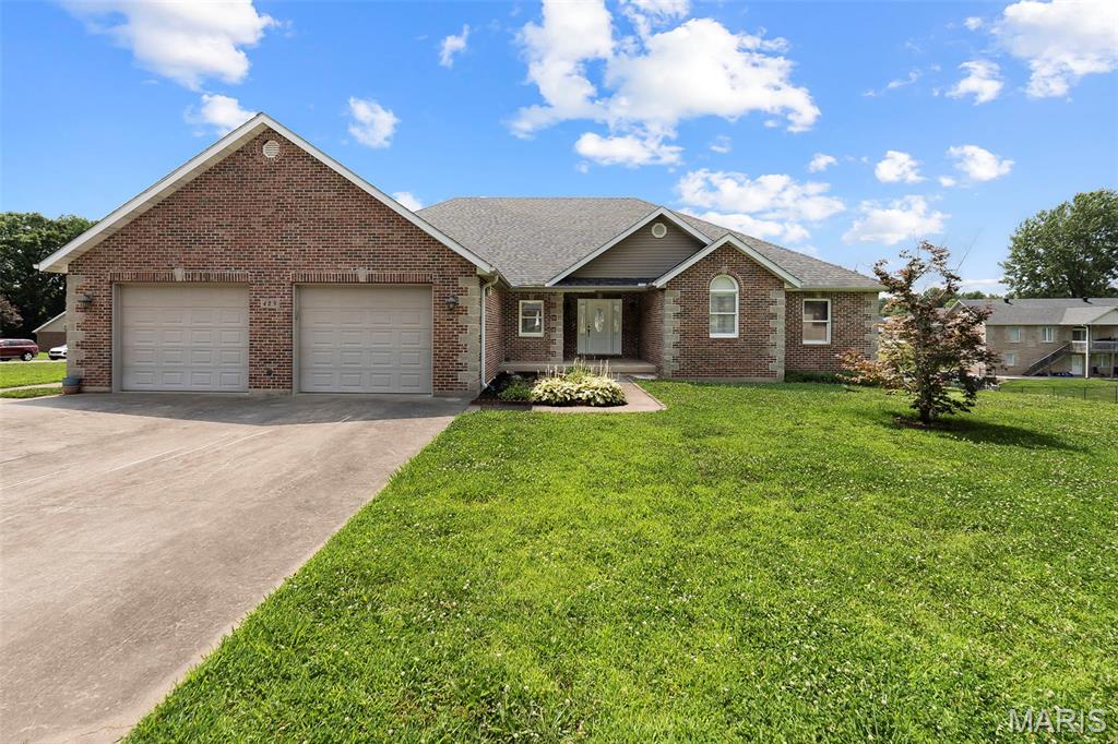 Don't miss this beautiful 3-bedroom, 3-bath all-brick home situated on a spacious corner lot with an additional lot included, offering extra room to enjoy or expand!

Inside, you'll find a welcoming great room with vaulted ceilings, creating an open feel. The kitchen features an island with eat-in dining, making it the perfect gathering space for family and friends. Convenient main-level laundry adds to the home's functionality.

The 2-car garage provides plenty of space for vehicles, tools, and storage. Downstairs, the full walk-out basement offers possibilities for future living space and is ready for the new owner to add finishing touches. The basement already includes a finished full bathroom, abundant storage space, a storm cellar, and a John Deere room with double-door access.

With solid brick construction, extra land, and room to customize, this home offers the perfect combination of comfort, space, and potential. Schedule your showing today!