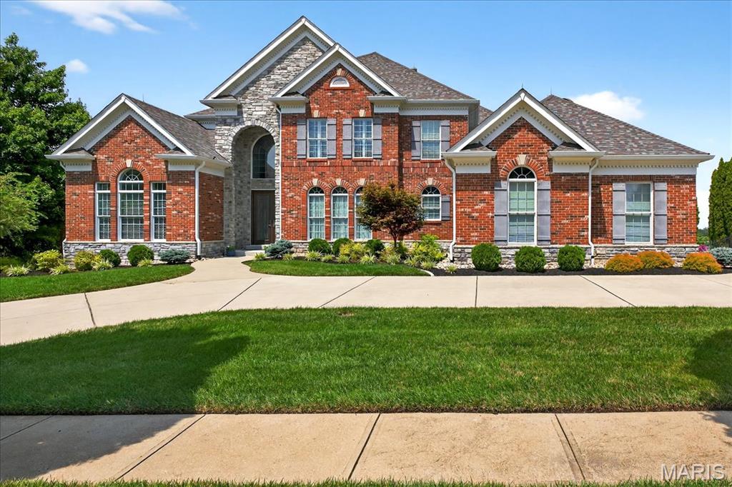 Welcome to this stunning 1.5-story home, fully updated throughout and designed for luxurious living and effortless entertaining. Step into the grand 2-story foyer that sets the tone, leading into the elegant dining room and private office. The dramatic 2-story Great Room features a wall of windows offering breathtaking views of the Chesterfield Valley and a cozy wood-burning fireplace. The gourmet kitchen is a dream, equipped with custom cabinetry, quartz countertops, a center island, butler's pantry, double dishwashers, gas range, beverage fridge, and ice maker. It opens to a sunny breakfast room and a vaulted hearth room with a striking stone gas fireplace and access to the screened-in porch. Retreat to the spacious main-floor primary suite with high ceilings, dual walk-in closets, and a luxurious ensuite bath featuring heated tile floors, separate vanities, and a walk-in smart shower & soaking tub. Upstairs, you’ll find 3 generously sized bedrooms, a Jack & Jill bath, a full bath, and a versatile bonus room. The walk-out lower level is an entertainer's paradise with a family room and fireplace, wet-bar area and wine room, media room, exercise room or potential 5th bedroom, and a full bath. Step outside to your private oasis with an in-ground pool and hot tub finished with ecoFINISH, built-in firepit, composite deck, screened-in porch, covered patio, and a beautifully landscaped yard. A circle driveway and 3-car garage complete this exceptional property. Truly a must-see!