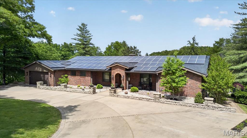 Welcome to this sprawling ranch set on a stunning, park-like 4.45-acre lot. Thoughtfully updated with style, this 3-bedroom, 3 full bath home offers the perfect blend of comfort, character and opportunity.  The beautifully renovated kitchen opens seamlessly to the family room, where vaulted ceilings, a striking wood beam and large picture windows bring the outdoors in. An open and inviting entryway, beautiful solid wood doors, a solid brick exterior and a circular drive add to the home’s timeless appeal.  Down the hall, you’ll find two bedrooms, a full bath and the private primary suite, complete with its own full bath, walk-in closet and deck overlooking the serene backyard. At the front of the home, a spacious office with French doors sits opposite the formal dining room, also featuring French doors, creating flexible and functional living spaces.  The kitchen and family room walk out to a spacious patio, ideal for outdoor dining and relaxing. The lower level is an entertainer’s dream, complete with an incredible vintage wood bar with stained glass, a lounge area, a large recreation room perfect for ping pong, skee-ball, and more, plus a full bath and an oversized room that could easily serve as a fourth bedroom. A walkout leads to the expansive patio and amazing pool, all surrounded by the beautiful park-like setting.  An added bonus: the property may offer parceling potential, creating a unique investment opportunity for those looking to maximize the land’s value. Buyer to verify with St. Louis County.  This is a home where you feel like you’re on vacation every day, yet you’re just minutes from everything.