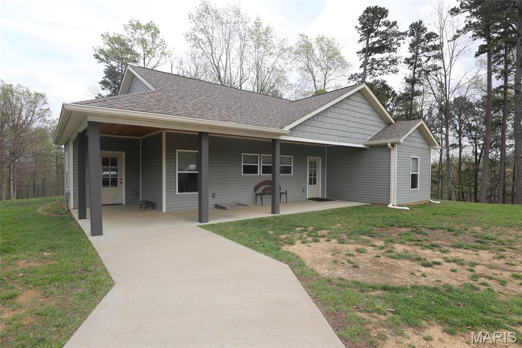 Beautiful 2 bed 2 bath home on 13.07 acres in Scarlet Ridge Estates. Built in 2021 with an open concept, craftmanship and attention to detail in every room. You will love all the natural lighting throughout the home! The kitchen has custom cabinets, range hood, granite countertops, an 8' island, farmhouse sink and stainless steel smart appliances. The master bedroom has double closets and a master bathroom. The second bedroom has the additional bathroom just next to it.  The huge utility room has been setup as a pantry, laundry room, and mud room inside the second entrance. There is also an oversized detached 3 car garage. Features include a storage room, smart garage door openers, its own septic tank, heat & air and hot water heater. There's a separate entrance in the garage that leads to an open office area with it's own half bath! Current owner purchased the 28x14 shed new in 2024 and it will be included in the sale.