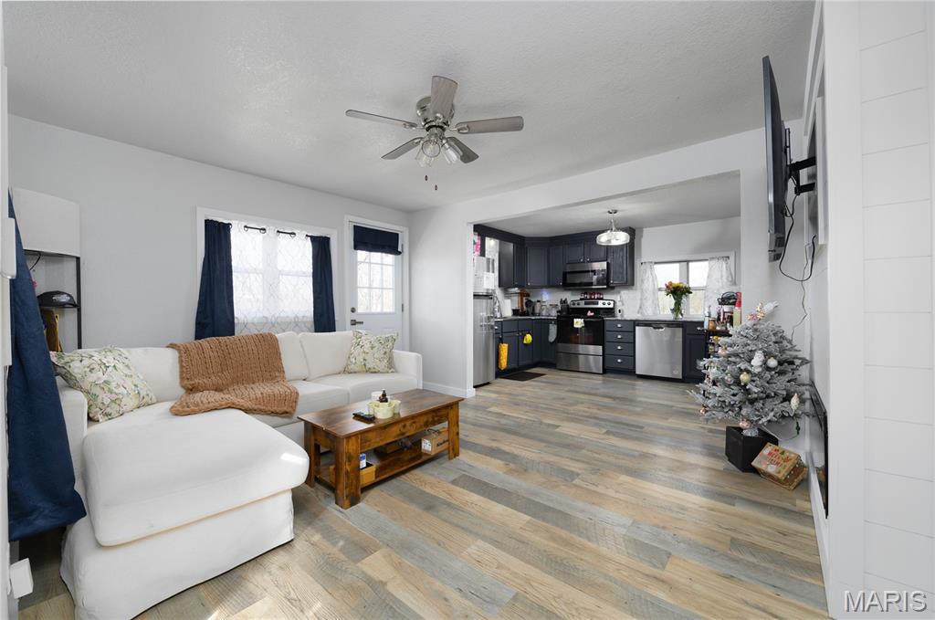 MOTIVATED SELLER AND WILLING TO HELP WITH CLOSING COSTS! Sitting on over ONE ACRE in a small, historic town in Pulaski County, Missouri, this fully remodeled 2-bedroom, 1-bath home is completely move-in ready. Enjoy the peaceful small-town feel while still being conveniently located between Waynesville/St. Robert, Fort Leonard Wood, and the Lake of the Ozarks.

Inside, you’ll find an open floor plan with waterproof Pergo plank flooring throughout. The beautifully updated kitchen features deep navy cabinets, granite countertops, and a chef-style sink that add character and charm.

Major updates include a 2024 METAL ROOF , recentlyreplaced WATER HEATER 2026 , and 200-AMP electrical service for peace of mind. PUBLIC WATER AND SEWER. The partial basement/cellar offers over 400 square feet of additional storage space.
Relax on the side deck and take in the spacious surroundings, with plenty of room to enjoy outdoor living. The area provides easy access to fishing, camping, and other outdoor recreation, making this the perfect blend of comfort and convenience.