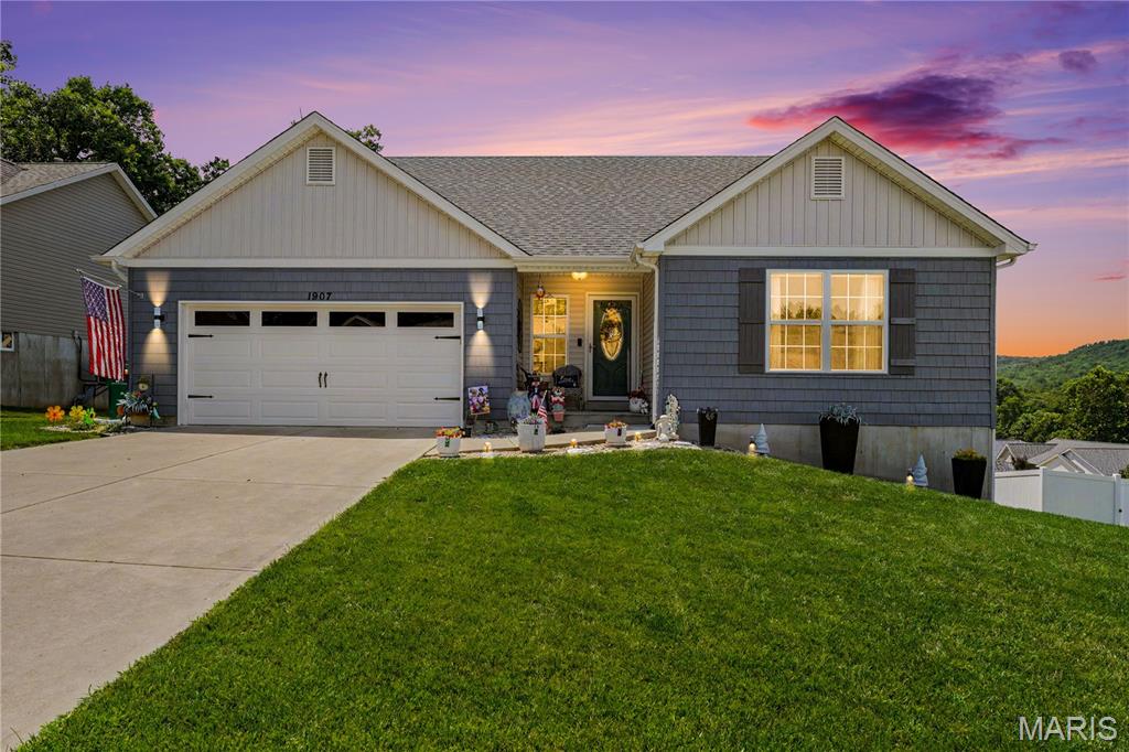 Welcome to this beautifully maintained 2019-built home in the highly sought-after Hunters Glen community, featuring a new roof (2025) and new rear siding (2025). This elegant 3-bedroom, 3-bath home blends modern design, comfort, and thoughtful upgrades throughout.
A charming covered front porch and professional landscaping create an inviting first impression. Step inside to an open-concept floor plan featuring newer luxury vinyl plank flooring, vaulted ceilings, natural light, and custom blinds. The spacious living area centers around a warm, inviting fireplace, with custom and upgraded lighting throughout the home enhancing warmth and ambiance. Main-floor living is a highlight with all three bedrooms and laundry conveniently located on the main level. The primary suite includes a walk-in closet and private ensuite bath.
The kitchen is designed for both everyday living and entertaining, featuring a reverse osmosis water system at the sink, a functional layout with pantry storage, and quality finishes including a stylish tile backsplash and cabinet accent lighting. The adjoining breakfast room and updated sliding doors extend the living space outdoors to a private retreat complete with a composite deck, black aluminum railings, and a retractable canopy overlooking peaceful wooded views.
The outdoor living continues with a newly poured patio beneath a covered pergola—perfect for entertaining or quiet evenings at home.
The walk-out basement offers a workspace and plenty of storage with partial drywall, framed in rooms, electrical, and plumbing already in place, along with a newly completed full bath—ready for your finishing touches and added value.
Move-in ready, low-maintenance living in a desirable community—don’t miss this one!