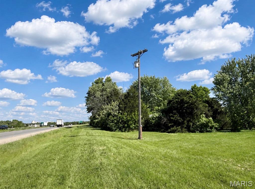 Just under 1 acre with highway frontage, Electric, Water and Sewer on site.  Currently zoned residential and would have to be rezoned to use as commercial.  Property has 2 mobile homes that are condemned but will be removed and a large metal building that can be removed if desired.