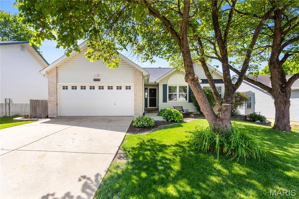 Welcome home to this well-maintained 4 bed, 3 bath home offering over 1,800 sq ft of finished living space! Ideally located next to Woodlands Park and Harvest Ridge Elementary, and backing to common ground for added privacy. The foyer features wainscoting and laminate flooring that flows throughout the main level. Vaulted living room with skylights, fireplace, can lighting, and accent wall creates an inviting space. The kitchen offers stainless steel appliances, quartz countertops, subway tile backsplash, pantry, breakfast bar, and eat-in area with sliding glass doors to the deck. The vaulted primary suite includes a walk-in closet and private bath with granite countertops, whirlpool tub, and separate tiled shower. Additional bedrooms are spacious and feature laminate flooring. The finished lower level boasts a spacious family room with gas fireplace, wet bar, built-ins, 4th bedroom with egress, and full bath. Enjoy the fully fenced backyard with deck, patio, and firepit—perfect for entertaining!