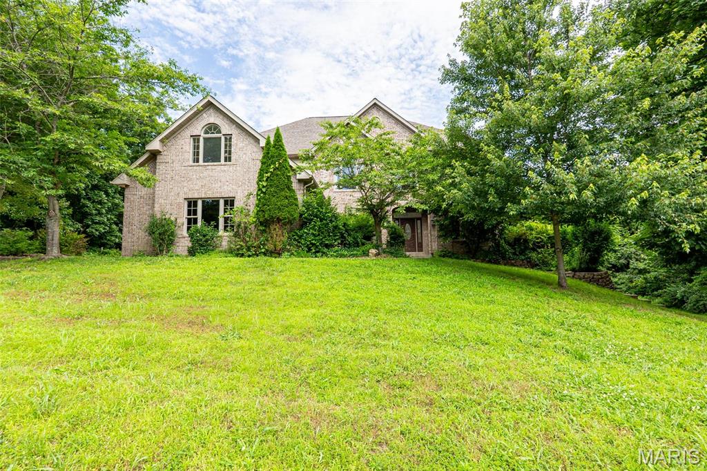 EXCEPTIONAL LUXURY IN SOUGHT-AFTER OAK KNOLL SOUTH!. This impressive all-brick residence offers more than 7,000 sq ft of beautifully designed living space, combining timeless elegance with everyday comfort.  Featuring six generously sized bedrooms (some non conforming)  and 4.5 baths, this home was thoughtfully crafted with quality finishes and room for everyone.  Step inside to soaring ceilings, rich hardwood flooring, and an inviting open-concept layout ideal for both entertaining and daily living.  the chef-inspired kitchen is the centerpiece of the home, showcasing granite countertops, stainless steel appliances, abundant cabinetry, and a seamless flow into the spacious living areas.  The main level primary suite provides a private retreat with ample space, over-sized walk in closets, and a luxurious en suite bath complete with dual vanities, a soaking tub, and a separate walk-in shower.  Upstairs, you will find four additional bedrooms, offering flexibility for family, guests, or home office spaces.  The finished walk-out lower level expands your living options with a large family room, dedicated theatre room, additional bedrooms and bath plus plenty of storage.  Outdoor living is just as impressive, featuring a multi-level deck overlooking the backyard-perfect for grilling, entertaining, or simply unwinding after a long day.  Ideally located in the desirable Oak Knoll South subdivision, this remarkable property offers convenient access to walking trails, shopping, dining, schools, and everything Rolla has to offer.  A rare opportunity to own a home of this size, quality, and location!
