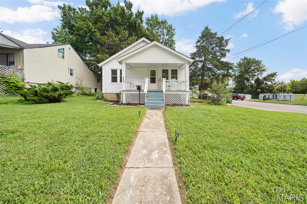 Welcome home to this charming bungalow in the heart of Rolla! Perfectly situated on a corner lot and just minutes from local parks, this inviting 2-bedroom, 1-bath home is full of character and opportunity. Relax on the welcoming covered front porch or enjoy the peaceful backyard views from the spacious deck. Inside, you'll find a cozy eat-in kitchen and comfortable living spaces filled with charm. The full unfinished basement offers laundry, a convenient tuck-under garage, and abundant storage or future expansion potential. Whether you're a first-time homebuyer looking for the perfect place to call home or an investor seeking to expand your rental portfolio, this delightful property is one you won't want to miss. Schedule your private showing today!