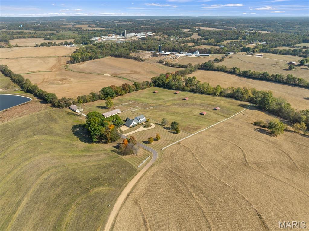 CONTINUE TO SHOW - 
An Equestrian's Dream Property!
Welcome to this breathtaking custom-built estate nestled on 19.75+/- private acres, designed with both luxury living and equestrian excellence in mind. From the moment you arrive, the scenic views, lush landscaping, and circle driveway set the tone for something truly special.
The centerpiece for equine enthusiasts is the 10-12 stall Morton horse barn, thoughtfully equipped with a tack room featuring a kitchenette and bathroom, wash rack, heated water system, and frost-free faucets. Each stall is crafted with 4-inch thick walls up to the windows for added durability. The fenced turnout pastures include automatic waterers and shelters, ready for your horses from day one. A second 32x72 outbuilding provides ample space for equipment and hay storage.
The stunning residence offers 5 spacious bedrooms and 5 full bathrooms, spread out over 4,800+ square feet of living space—ideal for a growing family or multi-generational living. The gourmet kitchen features custom cabinetry, granite countertops, and stainless steel appliances, opening to a dedicated dining area. The vaulted-ceiling living room centers around a gorgeous brick fireplace, perfect for cozy evenings. The main level also has a private, executive office space.
Step outside onto the screened-in deck just off the kitchen—your new favorite place to relax while taking in panoramic views of the surrounding land and pastures.
Main floor laundry with additional storage and direct access to the 3-car garage. Upstairs, the expansive primary suite features a fireplace, huge walk-in closet, and spa-like ensuite with jacuzzi tub, double vanity, and walk-in shower. Four additional bedrooms down the hall, all with ample space and large windows that allow for natural lighting. 
Partially finished lower level with a full bath—perfect for a home gym, homeschool space, or additional living space.  The tuck-under garage is ideal for a workshop, hobby space, or extra parking.

This property truly has it all—luxury, functionality, and unparalleled equestrian amenities. Don't miss your chance to own a slice of paradise. Schedule your private showing today and fall in love with everything this incredible property has to offer!