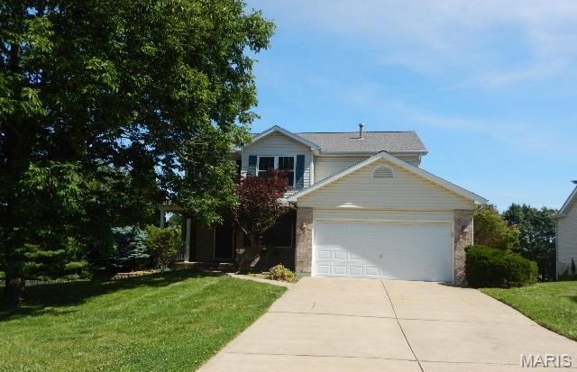 Spacious two story home with an attached two car garage! Special features include: wood floors, great room with fireplace, bay window, open two story entry, updated carpet, and much more!  Main floor has living room with built-in book shelves, kitchen and breakfast area, separate dining room, half bath and main floor laundry. Second floor has two full baths, three bedrooms and a media area on the second level. Lower level has family room, bar area, bedroom and full bath. Freshly painted, wood floors and new carpeting, ready for a new owner! Exterior has walk-out lower level, exceptionally large deck, patio off lower level, vinyl siding and located on a cul-de-sac!  Show, sell and move in, easy to show, set your appointment today!