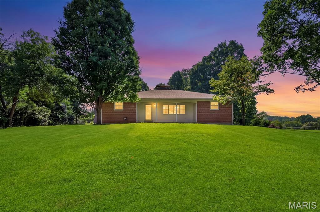 Welcome home to your own private retreat in the heart of Bridgeton! This 3-bedroom, 1.5-bath home has already passed the Bridgeton occupancy inspection, making for a smoother closing and move-in process. Situated on a private 0.66+/- acre lot, the home sits back off Taylor with a long, extended driveway, mature trees behind the property, and a spacious front yard that provides both privacy and plenty of outdoor space. The exterior you'll love! Features include the low-maintenance composite deck, perfect for relaxing or entertaining, along with the detached 3-car garage featuring a 2-car overhead door in the front and an additional single-car overhead door in the rear; Ideal for extra parking, storage, or a workshop. The glass enclosed sunroom is filled with natural light and offers a great spot to enjoy your morning coffee or unwind at the end of the day. Inside, the kitchen features updated flooring, brand new stainless steel appliances, and opens to the dining area for easy everyday living. The living room offers a cozy wood-burning fireplace and plenty of space to gather with family and friends. The primary bedroom includes a walk-in closet and washer and dryer hookups, while a second laundry area is located in the basement. The lower level is ready for your finishing touches and already includes two carpeted bonus rooms that work well as an office, hobby room, playroom, or additional flex space. The basement also offers custom shelving added in for extra convenience. In-addition, the HVAC system was just replaced a year ago! If you've been looking for a home that offers privacy, a large lot, great garage space, and room to make it your own, this Bridgeton property is one you won't want to miss.
