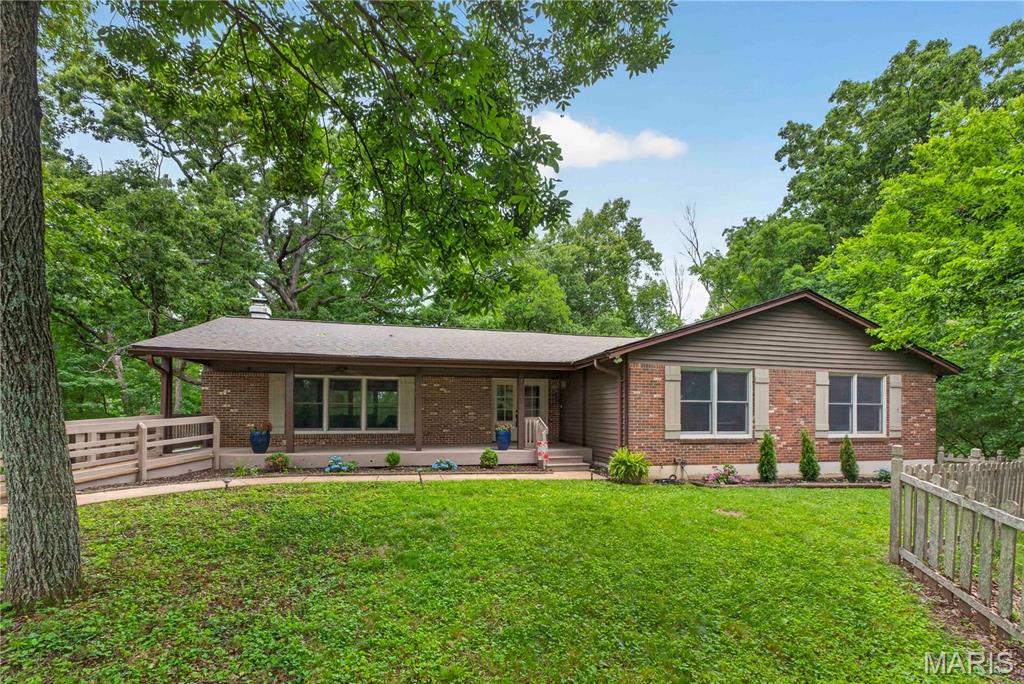 Tucked away on 3 private wooded acres in Wildwood and located in the award-winning Rockwood School District, this spacious ranch offers a rare combination of privacy, space, and natural beauty. Surrounded by mature trees with a partially fenced yard, the setting feels peaceful and secluded while still being close to everything Wildwood has to offer.
Enjoy quiet mornings on the large covered front porch and entertain with ease on the expansive back deck overlooking the scenic property. Inside, the heart of the home is the impressive family room featuring a stunning floor-to-ceiling stone, wood-burning fireplace that creates a warm and inviting focal point. Just beyond, the light-filled kitchen and dining area offer an abundance of space for gathering and entertaining, complete with a center island, pantry, and plenty of natural light throughout.
The main level includes 3 bedrooms and 2 full bathrooms, along with a versatile bonus room ideal for a home office, guest room, playroom, or additional sleeping space. Main-floor laundry adds everyday convenience. The expansive lower level offers abundant storage and additional space to customize for hobbies, recreation, fitness, or entertaining. A 2-car attached garage completes the home.
Major updates include a new roof and gutters in 2024 and new HVAC in 2021. With generous living spaces, a beautiful wooded setting, and a highly desirable location, this property is a wonderful opportunity to enjoy privacy and comfort in the heart of Wildwood. Lafayette High, Wildwood Middle, and Pond Elementary.