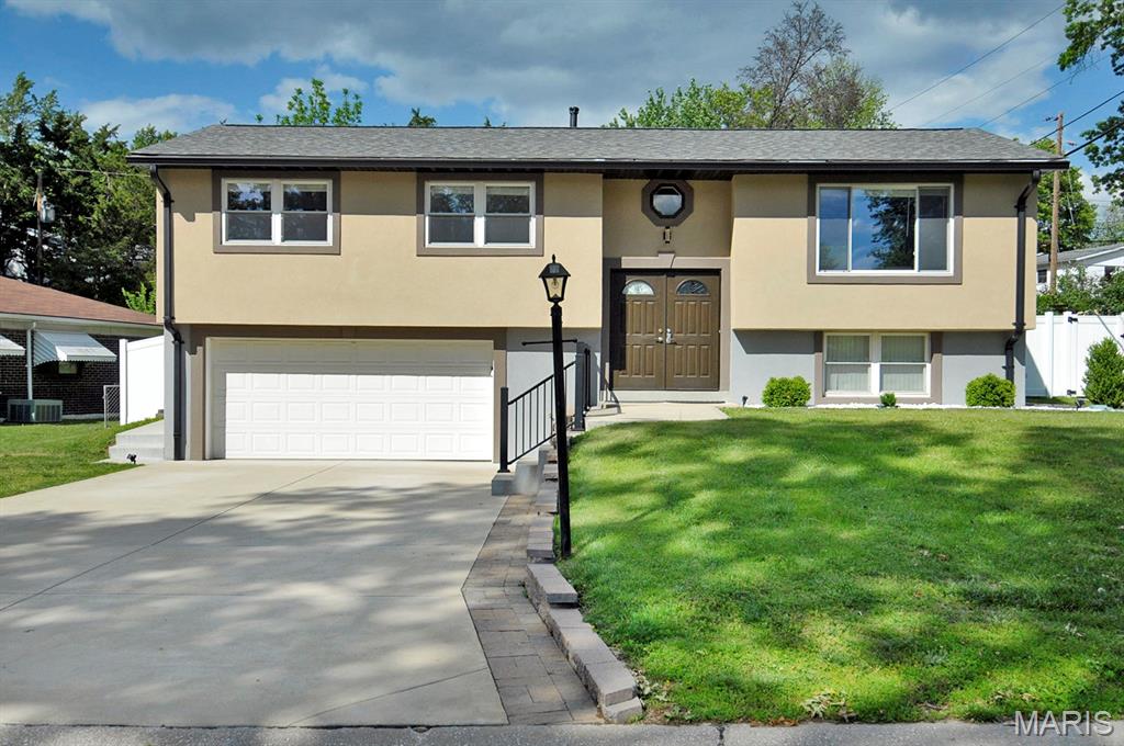 Back on the market! Welcome to 4921 Brockwood Drive, a charming split-level stucco home located in the highly sought-after Lindbergh School District. This 3-bedroom, 2-bath residence offers excellent curb appeal and is nestled in a welcoming, low-traffic neighborhood. Inside, you'll find a spacious kitchen featuring a large center island with built-in storage, creating the perfect space for cooking, entertaining, and everyday living. Step outside to a beautiful deck overlooking the fully fenced backyard, ideal for relaxing, entertaining, or enjoying outdoor activities. A two-car garage and wide driveway provide ample off-street parking for multiple vehicles. The home is equipped with a Trane dual-fuel HVAC system, combining an electric heat pump and gas furnace to provide energy-efficient comfort year-round by automatically adjusting to seasonal conditions. Offering a desirable location, thoughtful features, and functional living spaces, this home is a wonderful opportunity in one of South County's most sought-after communities.