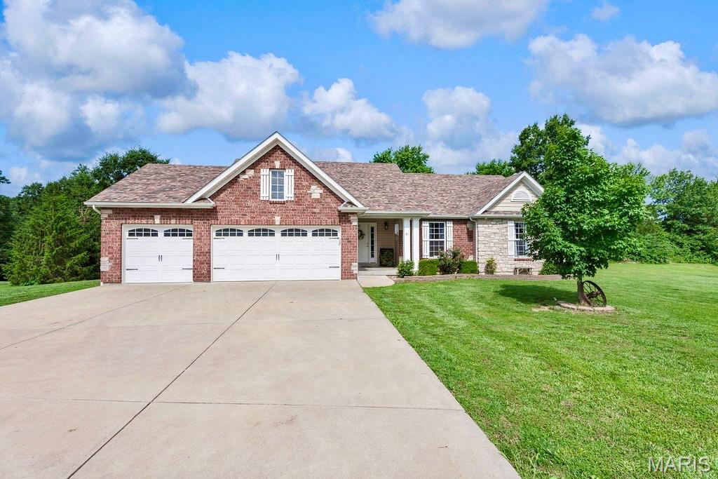 Welcome home to Pine Lake Estates, where peaceful country living meets stunning natural beauty.  Situated on approximately 2.4 acres in Southern Lincoln County, this beautifully maintained ranch offers picturesque water views, wooded privacy, and a park-like setting that's difficult to find.  The vaulted Great Room features rich flooring, a floor-to-ceiling stone fireplace, and an open-concept design that flows seamlessly into the spacious Kitchen complete with center island, abundant cabinetry, and large pantry.  The private Primary Suite provides a comfortable retreat, while the walkout lower level offers additional living space and future expansion potential.  Step outside to the cedar deck overlooking mature trees and tranquil surroundings, perfect for morning coffee or evening sunsets.  Enjoy the convenience of a 3-car garage, attractive soffit lighting, and a property that backs to woods while also offering beautiful pond views.  A rare opportunity to own acreage, privacy, and scenic beauty all in one exceptional package.