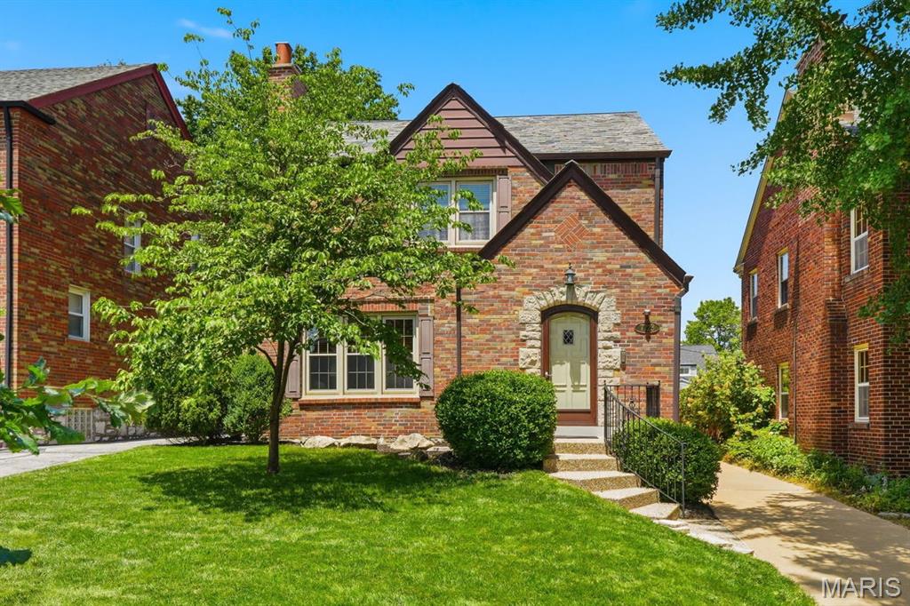 Prime U-City Living!
Fall in love with this enchanting Tudor Revival nestled in University City's sought-after West University neighborhood. Rich architectural character, thoughtfully curated jewel-toned interiors and inviting gathering spaces create a home that feels both timeless and welcoming from the moment you arrive. Step through the front entry and discover warm wood floors, beautiful French doors and cozy living spaces anchored by two arched, inset bookcases that flank the fireplace. The charming kitchen serves as the heart of the home, seamlessly connecting the front living areas to a peaceful, screened porch overlooking the private, landscaped backyard with a 2-car detached garage. Imagine morning coffee or evenings spent relaxing on one of two private decks or gathering with friends in your own serene outdoor retreat. Upstairs, three comfortable bedrooms offer flexibility and charm, including a spacious primary bedroom with room for a king-sized bed and a walk-in closet. One secondary bedroom enjoys direct access to the upper-level deck, providing a quiet escape. The finished lower level with walk-out access expands your living space with a large recreation room, full bath and abundant storage. Recent improvements include re-screened porch, updated copper gutters, and siding on the detached garage. Ideally located within walking distance of beloved neighborhood restaurants, shops and entertainment, this storybook Tudor invites you to enjoy the very best of University City while coming home each day to your own private sanctuary.