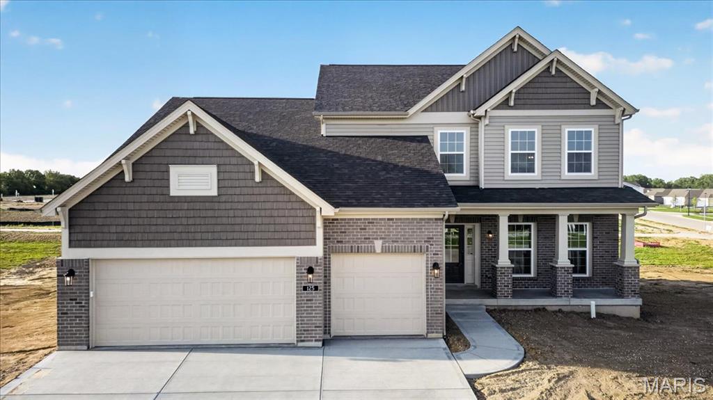 Beautiful home!! Located in the sought-after Montage community, this 1.5-story Expanded Bridgeport plan offers 3,340 square feet of well-designed living space with a Craftsman-style exterior. The home includes 4 bedrooms, 3.5 baths, and a 3-car garage. The kitchen features quartz countertops, a large island, two-tone 42” custom cabinetry with crown molding, soft-close doors, dovetail drawers, and stainless steel gas appliances. The open layout connects the kitchen to the breakfast room and family room, complete with a gas fireplace and a window wall for natural light. The main floor includes a study, laundry room with boot bench, and a spacious primary suite with a walk-in closet and private bath featuring a freestanding tub and separate spa like shower with heavy glass shower door. The upper level offers three additional bedrooms, two full baths, and a bonus room. Additional highlights include laminate flooring in main living areas, a full unfinished basement with rough-in for future bath, 8’ pour, and egress windows. Enjoy the 12x20 composite patio and included landscaping package. Zoned HVAC, smart thermostat, and energy-efficient insulated windows complete this move-in ready home in the Wentzville School District.