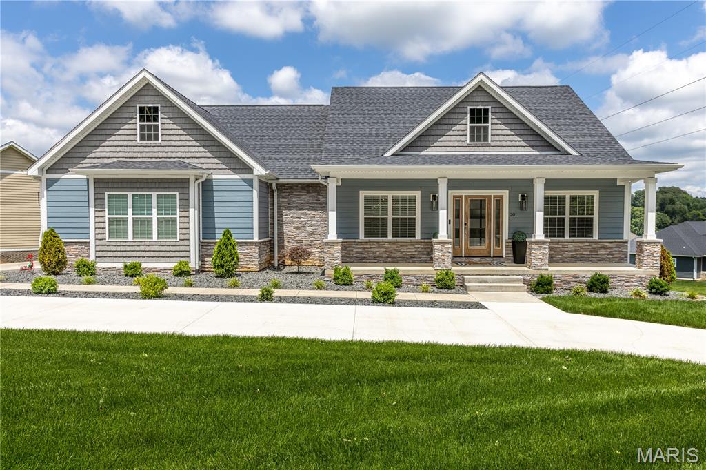 Located in the highly sought-after Meadows of Whispering Oaks subdivision and priced below appraised value! This gorgeous home was  built in 2023, boasts six-bedrooms, 3.5 baths and offers the perfect blend of modern design, open concepts and resort-style outdoor living. Step inside to discover a spacious open-concept floor plan perfect for nights at home or entertaining. The heart of the home features a beautiful kitchen with a large walk-in pantry, spacious center island and seamless flow into the dining and living areas. The finished lower level expands your living space with a stylish wet bar, making it the ideal gathering spot for game days, movie nights, and celebrations. Outside, you'll find an incredible backyard retreat that truly sets this home apart. Enjoy the expanded deck with a partially covered area perfect for relaxing or entertaining in any weather. The newly installed pool showcases stunning waterfalls, creating a private oasis right in your own backyard. An outdoor kitchen and beautiful stone wood-burning fireplace complete the space, offering year-round enjoyment and unforgettable evenings with family and friends. With six spacious bedrooms, thoughtful finishes throughout and an unbeatable outdoor living experience, this exceptional home delivers the lifestyle you've been dreaming of in the beautiful Meadows of Whispering Oaks subdivision.