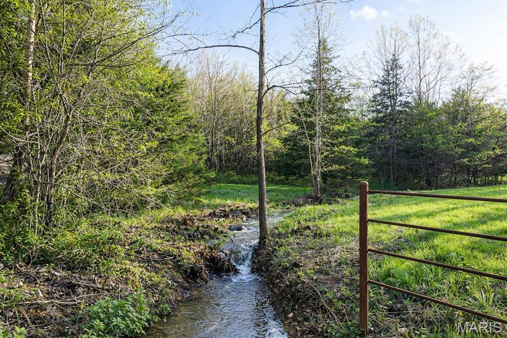 This 197+/- acre property on Brainerd Road offers a rare combination of proven hunting, natural beauty, privacy, and exceptional build potential in one of the most desirable recreational corridors in central Missouri.
Whitetail deer and turkey are abundant, and the property is well suited for serious hunting with a large, well-positioned blind already in place. A strong mix of mature timber, natural funnels, open ground, and water creates outstanding wildlife habitat and multiple opportunities for food plots and strategic stand locations throughout the property. Consistent wildlife activity has also been documented through trail camera footage, reinforcing the property’s reputation as a strong deer and turkey tract.
The recreational appeal is equally impressive. A well-established trail system allows for easy access across the property for riding, hiking, and exploring, while still preserving the sense of seclusion and privacy that makes a tract like this so special.
One of the most striking features of the property is its park-like entrance, where lush grass, mature timber, and a creek running alongside create an immediate sense of beauty and arrival. From there, the rolling terrain opens to multiple outstanding building sites with long-range views, ideal for a custom home, lodge, or luxury cabin.
Approximately 24+/- acres of open ground provide flexibility for food plots, small-scale farming, horses, or livestock, while the balance of the acreage is covered in mature timber that enhances privacy, habitat quality, and long-term land value. The open ground is positioned in multiple areas across the property, offering added flexibility for food plots, livestock, or separate build site options. A year-round creek, pond, and seasonal stream further strengthen the property’s functionality, wildlife value, and overall appeal.
With approximately 1,275 feet of road frontage on Brainerd Road and electric already running through the property, access and future development are both convenient and practical. The existing internal road system provides a strong foundation for continued improvement depending on the buyer’s vision.
Located approximately 30 minutes from Fort Leonard Wood and Lake of the Ozarks, this property offers an exceptional balance of accessibility and retreat.
Whether the goal is a high-quality hunting property, a private recreational getaway, or a scenic homesite with acreage and privacy, this is a property with the scale, setting, and features to support a truly special ownership experience.

"A premium recreational and stewardship property offering multiple opportunities to enjoy, manage, and preserve the land for generations to come."