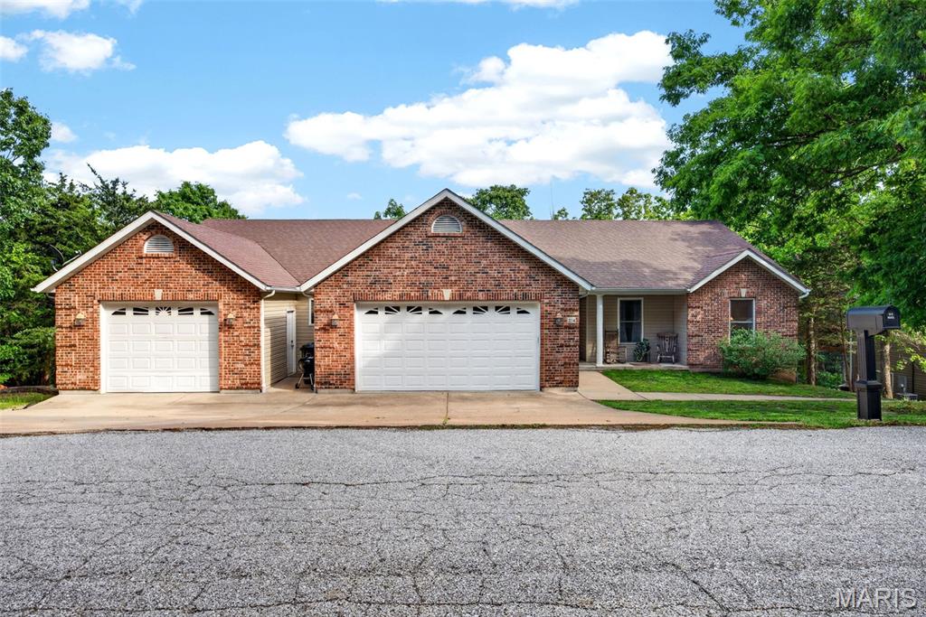 Rarely does a property come along that truly checks every box for a potential multigenerational, blended, or growing family — but this one does. Tucked into the serene, wooded cul-de-sacs of Raintree Plantation's lake and golf course community, this architecturally unique 4203+ sq ft estate was intentionally designed so two families can live together while maintaining complete independence. The upper level offers two master suites (one with a private sitting room), two additional bedrooms, a soaring vaulted great room, a well-appointed kitchen with large pantry/laundry combo, and a formal dining room that comfortably seats a crowd. Step out to the 14x12 sunroom and breathe in the treetops. The walk-out lower level is a fully self-contained living space with its own kitchen, four bedrooms, a generous family room/rec room, laundry and storage, and direct access to two tiered decks, a stone patio made for summer evenings. Built in 2005 with a thoughtful 2007 addition, the home sits on a private double lot near the front gate with all the seclusion of a nature retreat with the convenience of quick in-and-out access. A Country Club membership is included, and some accessible features are already in place. Homes like this don't come around often. Come see it for yourself.