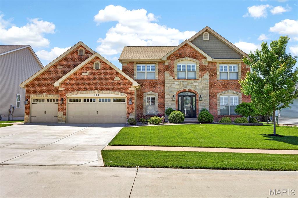 SHOWINGS WILL START FRIDAY 05-15-26. Must see this stunning home with a full brick and stone front, oversized 3-car fully drywalled and insulated garage with new driveway and walkway in 2024, plus beautiful landscaping in the front and back. This home offers 9-foot ceilings on the main level and has been updated with solid hickory wood floors throughout. As you enter, you will love the high ceilings, office, and dining room with custom woodwork.

The amazing kitchen updated in 2023 offers quartz countertops, custom upgraded cabinets, a large center island with breakfast bar, and stainless steel appliances. The breakfast area features a large bay window with sliding door that leads to a large exposed aggregate patio and fully fenced backyard with a walkway leading to the front. The large family room includes a 4-window bay and gas fireplace. There is also a half bath on the main level. Custom 4-inch plantation blinds are featured throughout the home. Large main floor laundry room with cabinets.

Upstairs you will find a huge vaulted primary bedroom with a large luxury bath offering double vanities, jetted tub, separate shower, and large walk-in closet. There are 3 other very good-sized bedrooms, 2 with walk-in closets, and all feature hickory wood floors.

The lower level, finished in 2019, offers a large family/game room with laminate flooring, a third full bath with tile flooring and tile shower, plus a large 5th bedroom with walk-in closet and large egress window. Sprinkler system in the front and back yards.

Plus, the roof, siding, and gutters were all new in 2024. All this in the highly desired Stonemoor Subdivision, which offers 2 pools, playground, basketball courts, and Rotary Park just across West Meyer Road from the subdivision Also within walking distance to the North Point Schools.