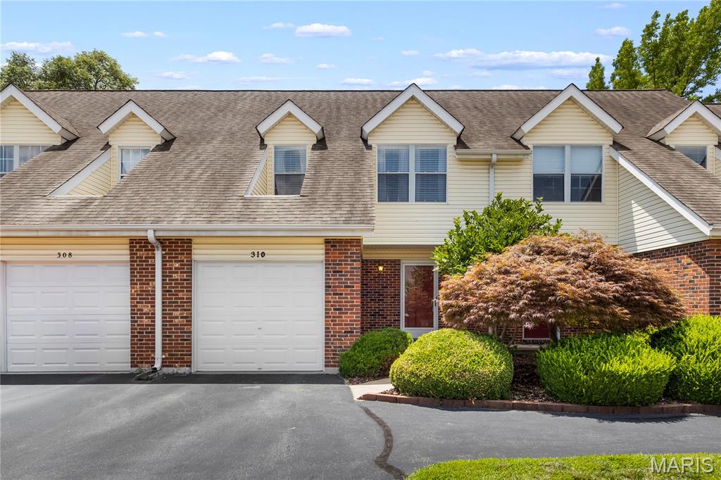 Welcome home to this beautifully refreshed townhome in the highly desirable Crown Colony community! Freshly painted with brand-new carpet throughout, this move-in-ready home offers the perfect combination of comfort, style, and low-maintenance living. Step inside to a dramatic vaulted great room featuring rich hardwood floors, a stunning floor-to-ceiling brick fireplace with gas logs, and an open layout that's perfect for relaxing or entertaining. The adjoining dining room continues the hardwood flooring, while the kitchen offers warm stained wood cabinetry, under & over cabinet lighting, and updated lighting fixtures for a modern touch. A convenient main-floor half bath completes the first level. Upstairs, you'll find an oversized primary bedroom, a generous second bedroom, and a full bath. The finished lower level adds valuable living space with brand-new carpet and fresh paint, making it the perfect media room, recreation room, home gym, or playroom. The laundry area is also conveniently located on this level. Enjoy peaceful mornings or evening gatherings on the newer deck overlooking beautifully maintained common ground. Additional highlights include a one-car attached garage, an assigned parking space, and access to the Crown Colony community clubhouse and swimming pool. Conveniently located near shopping, restaurants, parks, and major highways, this beautifully updated townhome offers exceptional value in one of St. Peters' most sought-after communities. Simply move in and start enjoying everything this home has to offer!