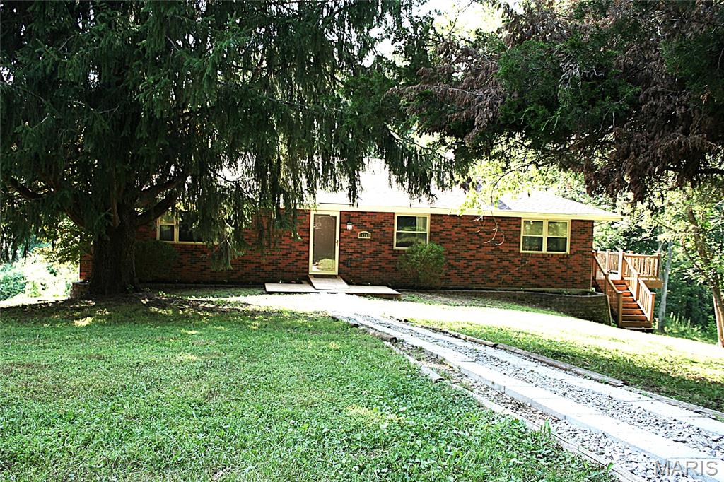 Nearly 2 acres of seclusion and privacy! This home is over 2100 sq ft and has so much to offer. Lets start with 2 fireplaces, 3 spacious bedrooms with the primary hosting an on suite, a sitting room and amazing views of the mature trees. Some of the key updates completed in 2022 include both main floor baths, kitchen cabinets, counters as well as update appliances, new roof and septic. The lower level features a rec room, family area, a huge bar for entertaining and a sleeping/workspace room.  The oversized windows allows a beautiful view of this amazing, private property and the breeze om the wrap around composite deck is amazing.