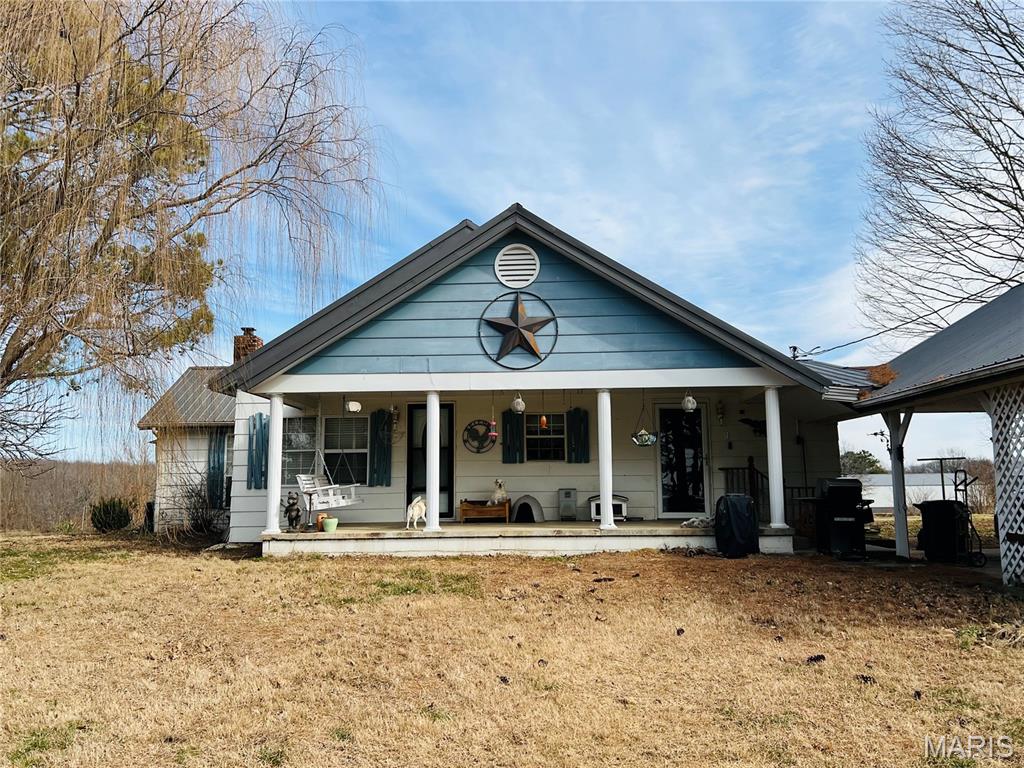 Looking for country living just outside of town? Here is the property for you! Look at this spacious farmhouse on 7 +/- acres with a beautiful STOCKED pond! This charming country home has 2 bedrooms and 2 baths with separate utility and a family room on the main level, as well as a bonus room in the upper level. The property boasts a large barn with a bonus room that has electric & water, as well as a smaller barn for storage! There is a concrete pad with water/electric hookups where a second home was previously located, perfect for another secondary home or shop with a view of the large pond!