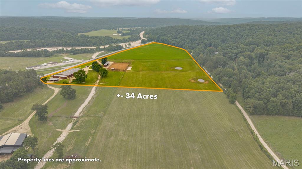 Discover an exceptional equestrian and recreational property just minutes outside of Ellington, Missouri, with outstanding frontage and easy access from Highway 106. Situated in the heart of the Missouri Ozarks, this versatile property is only 25 minutes from Eminence, close to the crystal-clear Current River, and surrounded by thousands of acres of Mark Twain National Forest, offering endless opportunities for horseback riding, hunting, trail riding, floating, and outdoor recreation.

At the center of the property is an impressive commercial grade 90' x 180' clear-span steel building designed for year-round use as horse training facility. Multiple oversized roll-up doors provide convenient access from every direction, while the interior is thoughtfully laid out to accommodate every discipline of horsemanship—from rodeo and performance horses to show horses and trail riders. The facility features an indoor round pen for specialized groundwork, a large working corral for advanced training, six WW horse stalls, a wash bay, hot walker setup, and a climate-controlled office complete with a bathroom, providing both comfort and functionality. An additional detached tack building with two more horse stalls offers extra storage and flexibility.

Outside, the improvements continue with a professionally designed outdoor riding and rodeo arena equipped with commercial-grade lighting, allowing for evening riding, training, and events. Additional features include multiple sorting pens, a return alley, loading area, numerous paddocks, and a concrete pad designed for bleacher-style seating, making this property well suited for clinics, competitions, and public events. Beautiful, well-maintained pasture is complemented by two ponds, four automatic livestock waterers, and durable four-rail pipe fencing surrounding the perimeter. A versatile covered two-sided storage building with a concrete floor provides flexibility and ample space for equipment, trailers, or hay storage.

Infrastructure is second to none with dual 200-amp electrical services already in place, potable water at multiple locations offering the capacity to support future expansion or additional improvements. Whether you're looking to operate a premier horse training facility, establish a boarding operation, host equestrian events, or simply enjoy an incredible private horse property in one of Missouri's top outdoor recreation destinations, this one-of-a-kind property is ready to make your vision a reality.