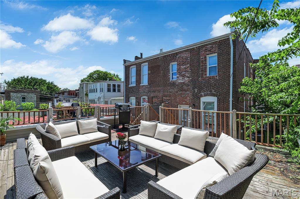 MOVE-IN-READY + BRAND NEW ROOF & GUTTERS! Experience elevated city living in the heart of the sought-after Shaw neighborhood, walking distance from the Missouri Botanical Garden (3 blocks), Tower Grove Park (2 blocks), trendy restaurants, cafe's, dog park (1 block), and nearby nightlife. This fully renovated residence blends historic character with sophisticated, modern luxury, offering an open-concept design tailored for today's lifestyle. The main level showcases rich bamboo hardwood flooring, soaring ceilings, and plenty of entertaining spaces. A show-stopping chef's kitchen offers abundant workspaces, custom cabinets, recessed lighting, and features quartz countertops plus slate flooring.  The custom butcher-block center island makes a statement with gas cooktop, and convenient pot filler. The main floor is rounded out with a breakfast / dining area with contemporary lighting, and a flex space that could be used as a den, office, or additional dining area. Off the main living area, a custom oak staircase with contemporary metal balusters leads to the second floor, where you'll find three spacious bedrooms, beautifully appointed baths, and convenient second-floor laundry. The expansive primary suite serves as a true sanctuary, highlighted by exposed brick, abundant natural light, an oversized walk-in closet with up-scale barn-door, and a spa-inspired bath featuring a custom quartz double-vanity, oversized custom tile walk-in shower, and private water closet. The basement offers a finished, secure home office area and the walk-up exit takes you outside to enjoy multiple levels of outdoor living, including a private rooftop deck 13x11, above the garage—an exceptional retreat for hosting friends, enjoying sunset cocktails, or unwinding under the city lights. Zoned heating & cooling w/ BRAND NEW UPPER HVAC. New Sewer Lateral, French Drain & Sump Pump - adding the extra reassurance of a dry basement. Rarely does a home combine this level of design, functionality, outdoor living, and walkability in one of St. Louis' most vibrant neighborhoods. Enjoy the best of urban luxury living with parks, culture, dining, and entertainment just steps from your front door.
