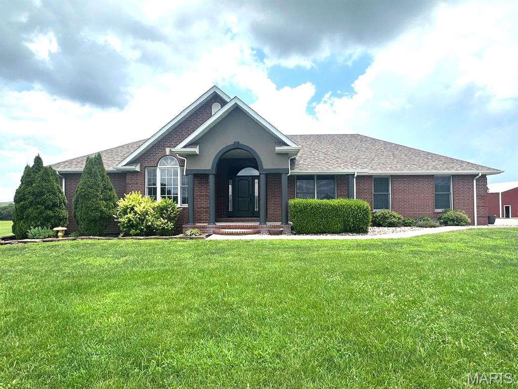 THIS MAJESTIC HOME OVERLOOKS NEARLY 17 ACRES OF LUSH PASTURE. AN ASPHALT DRIVE CIRCLES UP TO THE HOUSE, WITH A WHITE VINYL FENCE ALL ALONG THE WAY, TO ARTISTICALLY STAMPED CONCRETE IN FRONT OF THE GARAGE DOORS.   THERE IS ALSO A POND ON THE PROPERTY.   THREE BEDROOMS ON THE MAIN FLOOR.   LIVING ROOM HAS A GAS FIREPLACE AND THE DINING ROOM IS SEPARATE.  THE KITCHEN HAS MANY CUSTOM CABINETS, STAINLESS STEEL APPLIANCES, INCLUDING   A WALL OVEN, AND ELECTRIC COOKTOP.  THE KITCHEN LOOKS INTO THE LIVING ROOM OR OVER TO THE BREAKFAST AREA.   CERAMIC TILE, PLUSH CARPET, AND VINYL LAMINATE COVER ALL THE FLOORS BEAUTIFULLY.   THE MASTER SUITE INCLUDES A GREAT MASTER BATH WITH SEPARATE WHIRLPOOL TUB AND SHOWER, AND LARGE WALK IN CLOSET.  OUT THROUGH GORGEOUS LIVING ROOM WINDOWS YOU WILL FIND A GREAT PLACE TO RELAX, A NICE PATIO, BESIDE A GREAT IN GROUND POOL.  THE HOME HAS A WONDERUL FULLY FINISHED BASEMENT WHICH INCLUDES A GREAT FAMILY ROOM WITH FIREPLACE, A GREAT KITCHEN, AND A REALLY NICE BEDROOM AND BATH.  PLUS LOTS OF STORAGE.    FOR THE GUYS,   A LARGE 40X80  SHOP , WILL HOUSE ALL OF YOUR MECHANICAL TOYS,  TRACTORS, OR CARS AND TRUCKS.   THE SHOP ALSO HAS A 20 FOOT LEAN TO ON THE SOUTH SIDE.   THIS PLACE IS ONE OF A KIND, DON'T MISS THIS OPPORTUNITY BEFORE ITS GONE.   CALL TODAY!