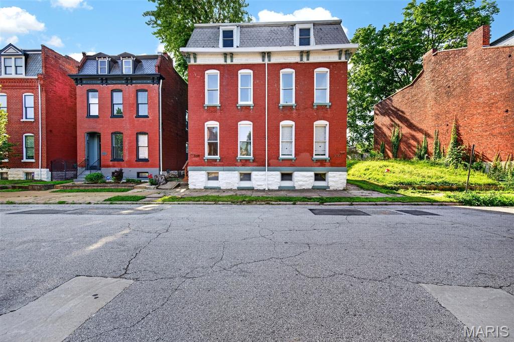 Step into this beautifully updated 3-bedroom, 2.5-bath home where historic character meets modern style. Sunlight pours through the bright, open floor plan, highlighting luxury vinyl plank flooring and striking exposed brick walls that add warmth and charm throughout the main level. 

The thoughtfully designed kitchen is both stylish and functional, featuring quartz countertops, crisp white cabinetry, stainless steel appliances, and a breakfast bar perfect for casual dining or entertaining. A versatile main-floor bedroom offers the flexibility of a guest room or home office, while a convenient half bath completes the level. 

Upstairs, the spacious primary suite serves as a private retreat with an oversized walk-in closet and ensuite bath. An additional bedroom, full bath, and laundry closet provide comfort and convenience on the second floor.

The third level offers incredible flexibility with a large family room ideal for a media room, playroom, home gym, or additional living space, plus a separate bonus room to fit your needs. The basement provides abundant storage space. 

Outside, enjoy a fenced backyard with a patio perfect for summer barbecues, outdoor entertaining, or relaxing evenings. The secure 2-car carport includes an alley-access garage door for added privacy and peace of mind. 

Ideally located just minutes from the vibrant shops, restaurants, and culture of Cherokee Street, beautiful Benton Park, and with easy access to I-55, this home offers the perfect blend of character, space, and convenience.