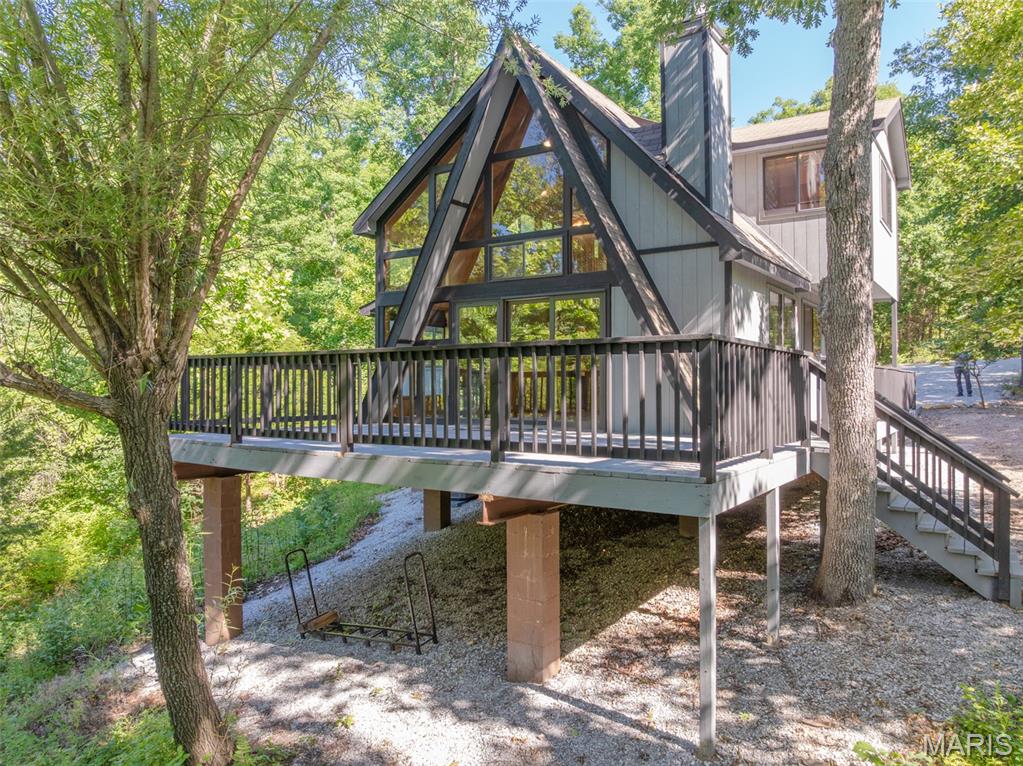 Tucked into 2.6 private acres, boasting Missouri hardwoods and just west of Lake Alpine, this well-appointed 2-bedroom, 2-bath chalet offers the rare combination of seclusion and convenience that Innsbrook buyers dream about. A flat, step-free entry welcomes you straight into the heart of the Chalet — no stairs, no hassle — where an enlarged kitchen with striking cedar ceiling sets the tone. Whether you're prepping a lake-day lunch or hosting after a round of golf, the space works as hard as you do. The great room anchors around a wood-burning stone fireplace that brings the best of Innsbrook's four seasons inside. Enjoy a main-level primary suite, while additional accommodations reside upstairs. Step outside onto the oversized deck and let the trees do the rest — this is the kind of privacy that's hard to find and harder to leave. The setting is as practical as it is peaceful. A boat launch on Lake Alpine and Kitzbuhl Beach are just a short drive away, and the community garden sits nearby for those who want to put down roots in every sense of the word. Offering a freshly painted exterior and deck, move-in ready, and loaded with the kind of details that make the difference between a good Innsbrook chalet and a great one. Properties on lots this size, this private, and this close to the water don't last. Come see why this Chalet is the one to call home!
