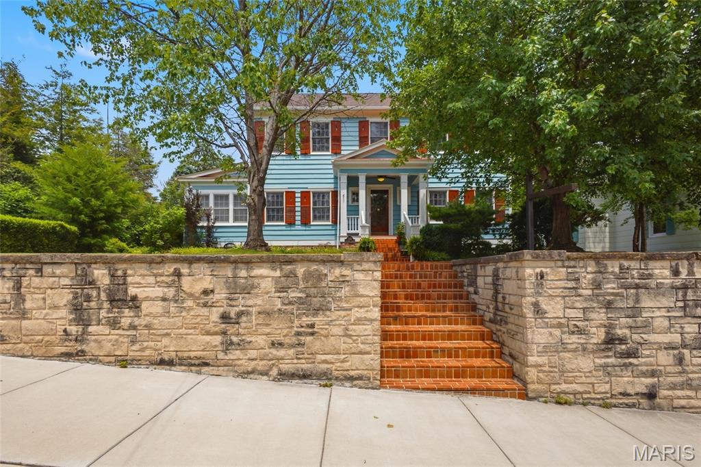 Unique Opportunity in Historic Ste. Genevieve! Own a beautifully renovated two-story Colonial in Ste. Genevieve's Historic District, where timeless charm meets modern luxury. This exceptional home features three spacious bedrooms, including a stunning primary suite with a private ensuite bath. The gourmet kitchen is designed to impress, offering a beverage/butler station between the dining room and kitchen, Boos butcher block walnut countertops, and a side-by-side built-in Sub-Zero refrigerator. Elegant formal living and dining rooms provide the perfect setting for entertaining, while the living room's cozy fireplace and charming window benches above custom built-in bookshelves lead seamlessly into a bright, window-lined sunroom—ideal as a reading nook, office, or flex space. The inviting family room showcases more built-in bookcases and cushioned window seats, a wood pellet stove to stay warm and cozy on cold evenings, plus floor-to-ceiling sliding glass doors, all creating the perfect gathering place for all-season occasions. Step outside to your own private backyard oasis featuring an inground saltwater pool, hot tub, heated greenhouse, shed, courtyard, lush landscaping, and a stamped concrete patio reminiscent of a smaller-scale Bridgerton garden retreat. A quaint second-floor balcony overlooks the beautifully landscaped grounds, offering a peaceful place to relax and unwind or get your day started. The finished lower level provides additional living space with two bonus sleeping rooms, a full bath, and a large recreation room perfect for guests, hobbies, or family activities. The romantic exterior is filled with private outdoor spaces for gardening enthusiasts, hobbyists, car lovers, or anyone seeking a tranquil retreat to enjoy a good book by the pool. Additional highlights include: Detached two-car garage, charming pool house with front porch that can double as a guest house/in-law quarters featuring a relaxing/sleeping area, kitchenette, and full bath. Mature landscaping and multiple outdoor entertaining areas grace these grounds. This one-of-a-kind property combines historic character, modern amenities, and exceptional outdoor living in the heart of one of Missouri's most treasured communities. A must-see home that truly has it all!