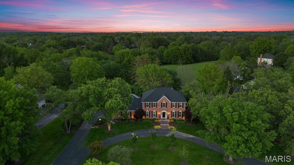 PROPRT SOLD AS IS.  NO REPAIRS OR CONCESSIONS. In the most coveted location of this prestigious community, this custom, STL brick faced executive home radiates timeless elegance and superior craftsmanship. Inspired by the charm of the French countryside and classic English estates, its light-filled interiors blend sophistication with warmth. Designed for both grand entertaining and intimate living, the open floor plan showcases expansive rooms, a welcoming family room, and a chef’s kitchen overlooking a custom pool, manicured gardens, and a serene greenway.  The main-level laundry offers added convenience. The recently renovated primary suite is a spa-like retreat, while three additional bedrooms provide peaceful sanctuaries with a shared elegant bath. The walk-out lower level is a dream space for the sports enthusiast or hobbyist, complete with a full bath and direct greenway access.  A residence designed for fluid transitions between interior and exterior spaces. A rare opportunity to own one of the finest homes in the community.