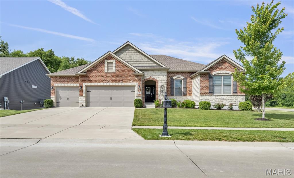 Stunning luxury ranch featuring the highly sought-after Indigo floor plan by Lombardo Homes, perfectly designed for modern, open-concept living. Built in 2019, this exceptional home offers over 2,560 square feet on the main level with refined finishes, 9-foot ceilings, and a layout that feels both expansive and functional. Curb appeal shines with a striking brick and stone front elevation complemented by a spacious three-car garage, setting the tone from the moment you arrive.

The main floor offers 3 bedrooms, 2 full baths, and 1 half bath, along with a versatile flex room currently used as a home office—perfect for today’s lifestyle needs. At the heart of the home, the Indigo’s signature design delivers an exceptional entertaining space, where a spacious great room flows seamlessly into the gourmet kitchen and dining area. The kitchen features abundant cabinetry, a large multi-sided island, and an inviting nook that connects effortlessly to outdoor living.

Privately positioned, the owner’s suite is tucked away on its own side of the home, offering a quiet retreat complete with a coffered ceiling, generous walk-in closet, and a spa-inspired bath featuring a separate soaking tub and walk-in shower. A dedicated family entry and main floor laundry enhance everyday convenience.

Step outside to a 24’ x 14.5’ maintenance-free deck with a spiral staircase leading to a covered patio below—creating multiple outdoor living spaces ideal for entertaining. The walkout lower level features a full 9-foot pour, large windows, and rough-in plumbing, offering incredible potential for future finished living space.

Enjoy a stunning, level corner lot featuring a fire pit and seating—an ideal setting for outdoor entertaining and quiet evenings at home.

Located in Brookside Estates, residents enjoy access to outstanding neighborhood amenities including multiple parks and playgrounds, walking trails, a basketball court, a stocked lake, and a community pool. All of this is conveniently located near highways, shopping, dining, and within the award-winning Fort Zumwalt North School District.

This is a rare opportunity to own a beautifully designed home with one of Lombardo’s most desirable floor plans. Schedule your private showing today.
