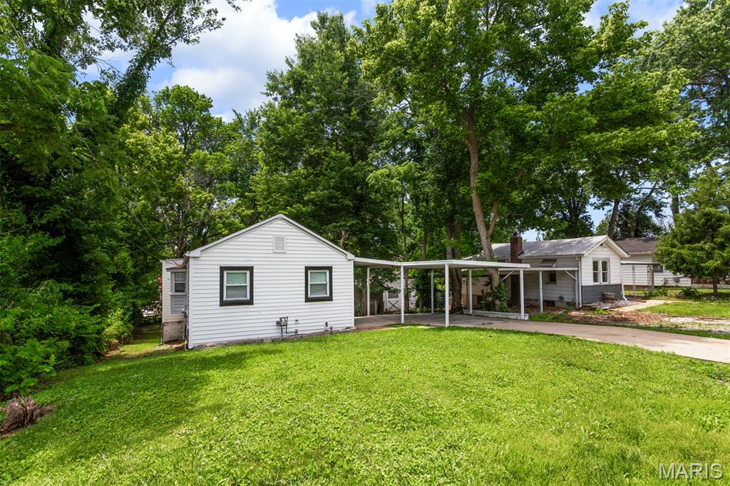 Welcome home to this move-in ready bungalow style home featuring 2 bedrooms and 1 full bathroom. As you step inside you will notice a spacious living room that leads you around to the eat-in kitchen. Kitchen is complete with tons of cabinet and counter space with a delightful bay window above the sink allowing tons of natural light through. Both bedrooms are nicely sized with large closets. The bathroom has been updated with an oversized vanity offering tons of storage space and a tub/shower combination. Downstairs to the walk-out basement you will find tons of storage space, a laundry area and room to complete for additional living space or recreational room. Onto the exterior with a large back deck overlooking the fenced in yard that is perfect for relaxing on a nice day or entertaining guests. A convenient shed sits in the backyard for all your yard equipment and extra storage. This home also has a carport for covered parking and an long driveway for extra off-street parking as well. Location is key with many desirable restaurants, shopping centers and entertainment venues close by. Make your appointment today to come check out this adorable bungalow today!