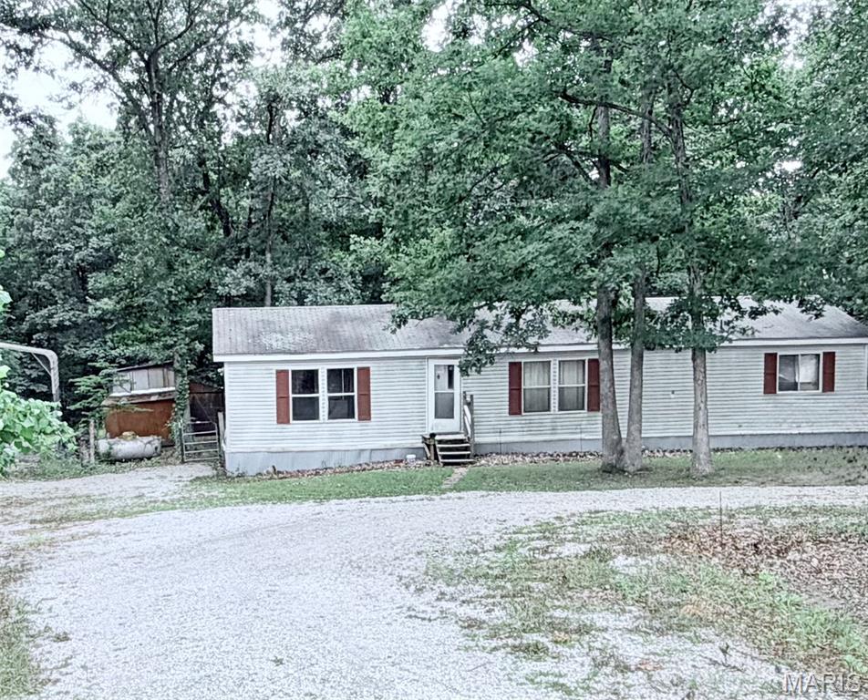This 3-bedroom, 2-bathroom trailer is being sold in as-is condition and presents an opportunity for someone looking for a property with potential. The home needs a couple significant repairs and updates, including a new roof, replacement of flooring in the laundry room, and additional renovations throughout. While the property is currently in need of work, it has the potential to become a much more comfortable home with the right vision, time, and investment. This is a true blank canvas waiting for someone with creativity and ambition to bring it back to life. With some hard work and a little imagination, this property could be transformed into a place you'll be proud to call home on almost 2 1/2 acres of privacy. This one is ready for its next chapter!