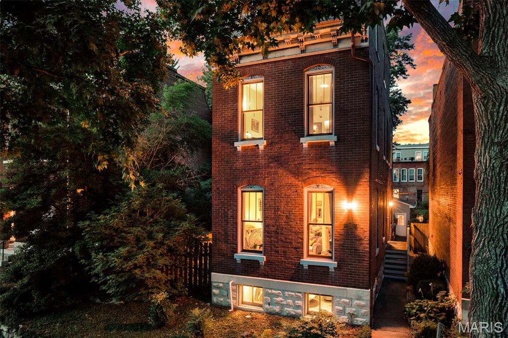 Classic Benton Park charm meets modern convenience in this impressive 3-story brick Victorian situated on a rare double lot. Featuring 3 bedrooms, 2.5 baths, and a detached 2-car garage, this home offers space, character, and functionality in one of St. Louis' most desirable neighborhoods.
Step inside to find beautiful hardwood flooring, exposed brick accents, and an inviting open floor plan designed for everyday living and entertaining. The spacious kitchen features a gas stove, pantry, and easy access to the separate dining room. French doors lead to a private deck overlooking the fenced yard, creating the perfect indoor-outdoor living space.
The second level includes two generously sized bedrooms, a full bath, convenient laundry area, and a charming balcony. The entire third floor is dedicated to the private primary suite, complete with an en suite bath, plus stunning views of the St. Louis Arch.
Additional features include an unfinished basement offering abundant storage, privacy fencing, modern systems, and energy-efficient windows. Enjoy relaxing on the covered side porch while taking advantage of the spacious double lot and outdoor living areas.
A rare opportunity to own a character-filled Victorian with modern updates, outdoor space, and an unbeatable Benton Park location.