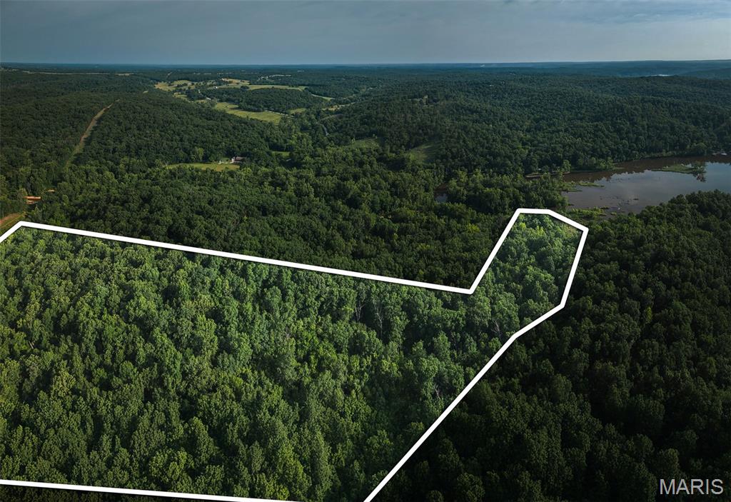 A rare find at Lake of the Ozarks—26.5 +/- wooded acres with county road frontage AND lake frontage on one of Missouri’s most desirable recreational lakes. This tract delivers privacy, natural beauty, and investment potential that’s hard to duplicate.

Mature hardwoods, rolling terrain, and multiple buildable sites create an ideal setting for a secluded lake retreat, cabin build, or estate-style home tucked into the timber. Enjoy fishing, kayaking, quiet paddles, and peaceful mornings along your own shoreline.

For hunters, this acreage is a natural travel corridor. Deer, turkey, and small game thrive here thanks to excellent bedding cover, diverse habitat, and nearby water. Fall days are alive with activity, and quiet mornings bring the sounds of the lake waking up.

Convenient to marinas, boat ramps, restaurants, and local amenities—yet perfectly removed for peace and privacy—this property supports development possibilities, long-term investment appeal, and private living all in one.

Acreage with road access and Lake of the Ozarks frontage is incredibly hard to find. Build, relax, recreate, or invest—your Missouri retreat starts here.

Agent/Owner