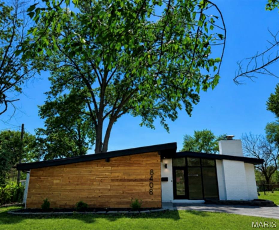 Modern style meets everyday comfort in this beautifully updated home offering 1,648 square feet of living space and incredible curb appeal! From the striking exterior design to the thoughtfully updated interior, this home is move-in ready and waiting for its new owner(s). Inside, you’ll find gorgeous LVP flooring throughout, vaulted ceilings, and a spacious living room with a fireplace. The beautifully updated eat-in kitchen features granite countertops, an island/breakfast bar, vaulted ceilings, frosted subway tile backsplash, new cabinetry, and stainless steel appliances. Additional features include a spacious primary suite with a private updated full bath, separate dining area perfect for entertaining, and a bonus room offering flexible living space that could be used as a playroom, office, workout room, or more. There are also three additional bedrooms and another updated full bathroom with a shower. Step outside to enjoy the back porch overlooking the large fenced backyard. An exterior storage closet and covered parking add extra convenience, while the unique modern exterior gives this home a truly one-of-a-kind feel. Additional updates include the HVAC system, water heater, windows, doors, siding, gutters and downspouts, new flooring, fresh interior and exterior paint, plus a resurfaced driveway and roof. All offering added peace of mind for the new owner(s). This home is a must-see!