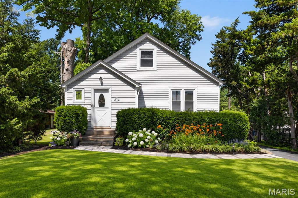 Welcome home to this charming and well-maintained Florissant gem! This inviting home offers 3 bedrooms, 1 full bath, and a detached 2-car garage, blending timeless character with everyday comfort. From the moment you arrive, you'll appreciate the attractive curb appeal, spacious front yard, and long driveway providing ample parking. Step inside to discover a bright eat-in kitchen featuring white cabinetry, countertops, vinyl tile flooring, and plenty of natural light. The spacious living room and formal dining room showcase stunning refinished original hardwood floors, elegant wood trim details, and charming arched doorways that add warmth and character throughout the home. The main-floor primary bedroom offers natural hardwood flooring, a ceiling fan, and double closets for abundant storage. Upstairs, you'll find two additional bedrooms filled with character, including charming built-in twin beds, walk-in closet space, and ceiling fans/lights. Relax and unwind in the enclosed covered porch overlooking the level backyard, perfect for morning coffee, entertaining, or enjoying the seasons.  The roof is 1 year young. The detached 2-car garage and spacious yard provide plenty of room for hobbies, gardening, and outdoor activities. The clean, freshly painted unfinished lower level offers tremendous storage space and endless possibilities for future expansion, a workshop, home gym, or recreation area. Convenient Florissant located near public transportation, shopping, restaurants, parks, and major highways, this move-in-ready home is full of charm, character, and opportunity. Don't miss your chance to make it yours!