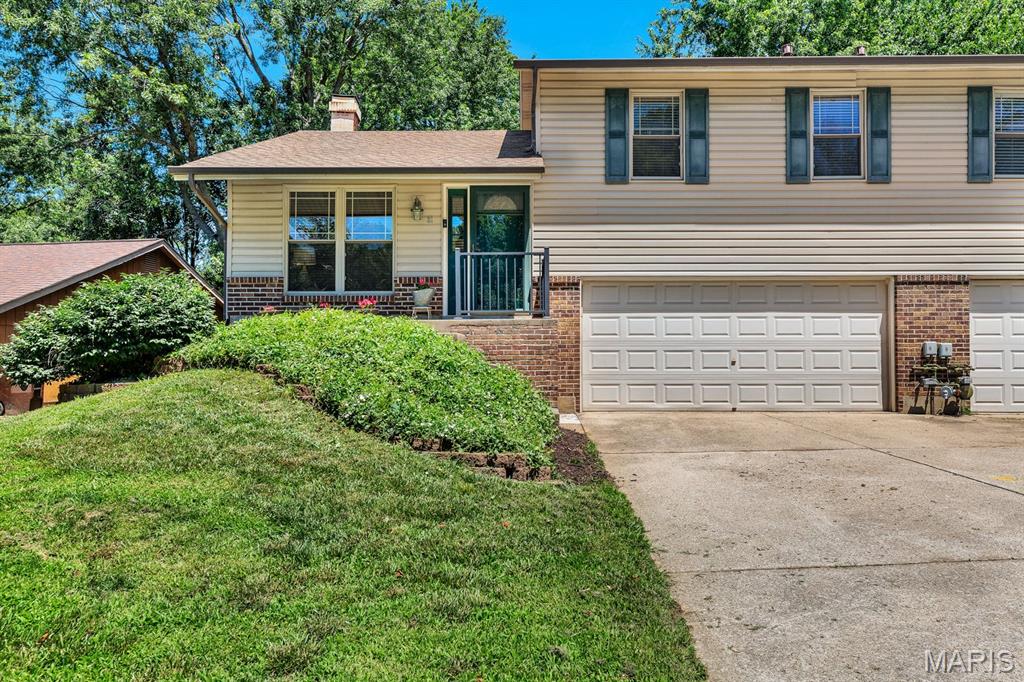 Recently updated and move in ready two-bedroom, two bath, 1/2 Duplex. Updates include: new kitchen cabinets, new quartz countertops, new range and microwave. luxury vinyl plank flooring throughout. Primary bedroom has updated walk-in shower. Home also has newer HVAC and a new retaining wall. 
Open floorplan with vaulted ceilings in family room with corner wood burning fireplace. Beautiful custom wood stairway to upper level. Finished lower level with extra cabinets for storage and walkout to the two-car garage. This community has NO HOA or CONDO Fees.