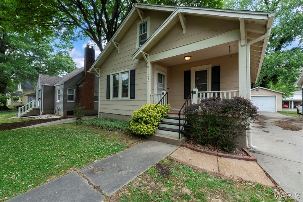 Classic bungalow character and meaningful updates create a rare combination of charm, functionality, and future potential in this centrally located Cape Girardeau home. From the covered front porch to the original millwork, hardwood floors, vintage built-ins, and wide cased openings, this home delivers the warmth and personality buyers look for in a classic early-century property. The spacious kitchen offers abundant custom cabinetry, stainless appliances, exposed brick accents, and generous workspace, blending vintage appeal with practical use. The bathroom features a clawfoot soaking tub with room to add a clawfoot tub shower kit if desired. Approximately 263 additional upstairs square feet provides excellent potential for future finished living space as a possible third bedroom, office, or bonus area. Major improvements include new AC in 2023, PEX plumbing updates in 2022, water heater in 2021, updated electrical panel, 2018 roofs on both the house and detached garage, gutters added in 2022, and partial sewer line replacement completed in 2015. The unfinished basement includes a separate shower plus additional plumbing potential for future sink and toilet installation, offering a strong opportunity for a second full bathroom along with substantial storage and utility space. Outside, the fenced backyard features a large deck, screened porch, detached garage, storage shed, mature trees, and alley access. Conveniently located near Southeast Missouri State University, shopping, dining, schools, and healthcare facilities, this property offers character, updates, and flexibility in the heart of Cape Girardeau.