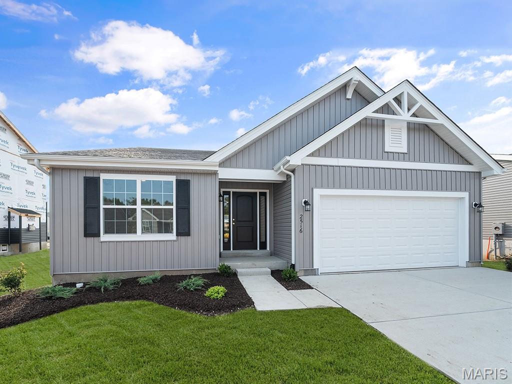New McBride Homes Aspen II 3BR, 2BA ranch floorplan, move-in ready this winter! Farmhouse exterior and walkout homesite! Enjoy an open floorplan w/vaulted ceilings, 6’ windows, & beautiful wood laminate flooring in main living areas. The kitchen has a large island w/ breakfast bar, Landen Flagstone 42” cabinets, quartz countertops, stainless steel GE appliances, & large walkin pantry. The dining area has a sliding glass door that leads to a covered future deck area w/ceiling fan prewire. The primary suite has a large window, dual closets, & private bath w/double sinks & walkin shower. Other extras include main floor laundry, ceiling fan prewires, ¾ bath rough in at LL, six panel interior doors, plus coach lights by 2-car garage. Located in House Springs, this community features 263 homesites off Bear Creek Road, just east of Gravois Road and Carol Park Road. Enjoy peace of mind with McBride Homes’ 10 year builders warranty & incredible customer service! Similar photos shown.