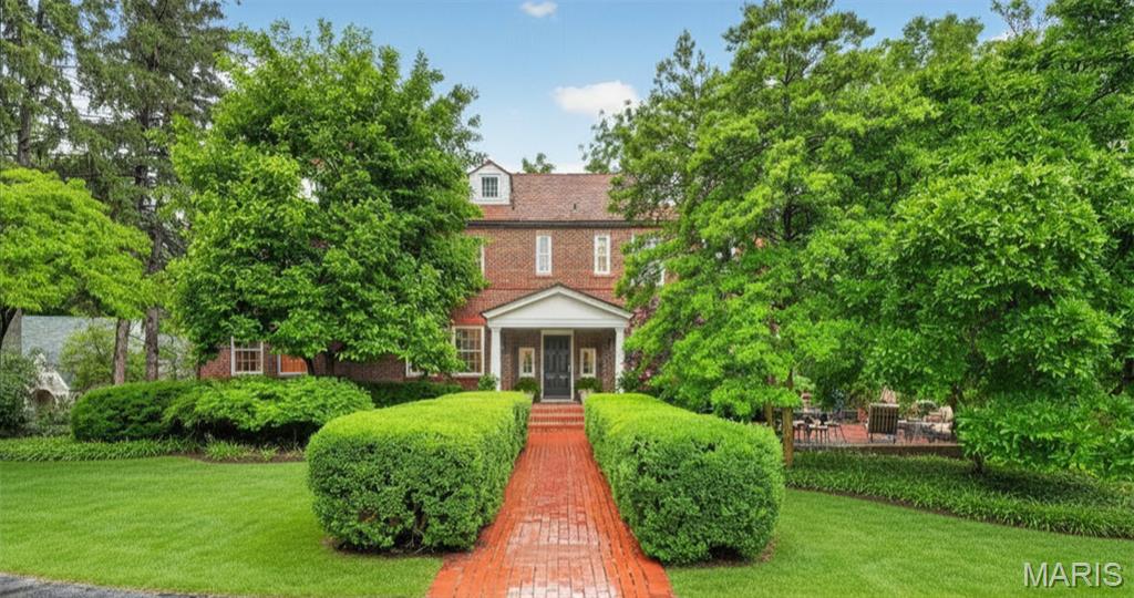 Built in 1936, this charming 4-bedroom, 4.5-bath home beautifully blends timeless architectural character with thoughtful modern updates in a prime Ladue location. From the moment you arrive, the inviting front patio and picturesque 1+ acre lot set the tone for this special property. Inside, rich wood floors, high ceilings, and significant architectural details create warmth and elegance throughout. The spacious living room offers an ideal setting for both everyday living and entertaining. A functional main-floor laundry room adds convenience to the home’s classic layout. The expansive primary suite is a true retreat, featuring a private sitting room or office, generous closet space, and a spacious bath with separate vanities, a soaking tub, and large shower. Three additional bedrooms and two full baths complete the second floor, offering ample space for family and guests. The finished lower level provides additional living and entertaining space along with a full bath, ideal for a recreation room, fitness area, or guest suite. Surrounded by mature landscaping and set on over an acre, this exceptional property offers privacy, beauty, and convenience in one of Ladue’s most desirable locations. A rare opportunity to own a home filled with charm, character, and modern comfort.